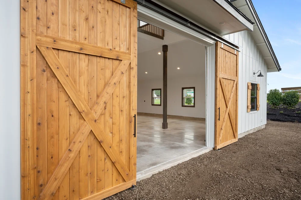 Close view of the cedar barn doors opened to the main-floor space.