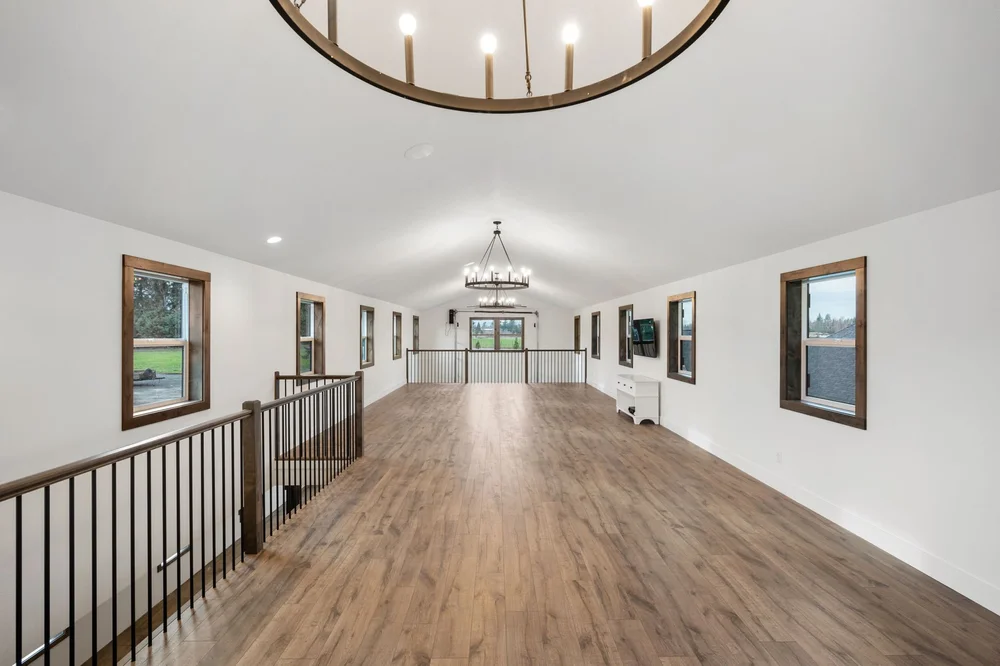View down the length of the upstairs loft beside the stair railing.