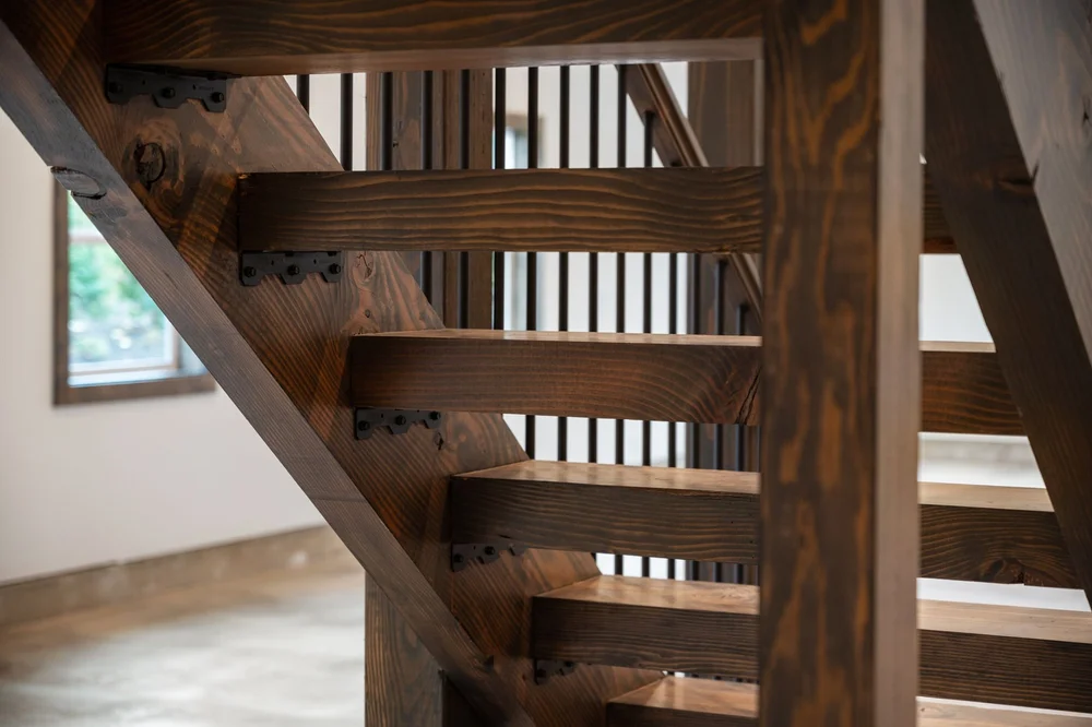 Close view of the wood treads and structural details beneath the staircase.