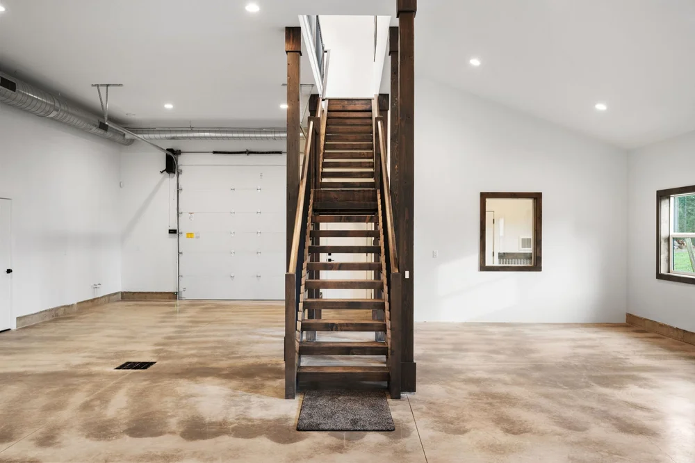 Front view of the wood staircase and its dark metal balusters.