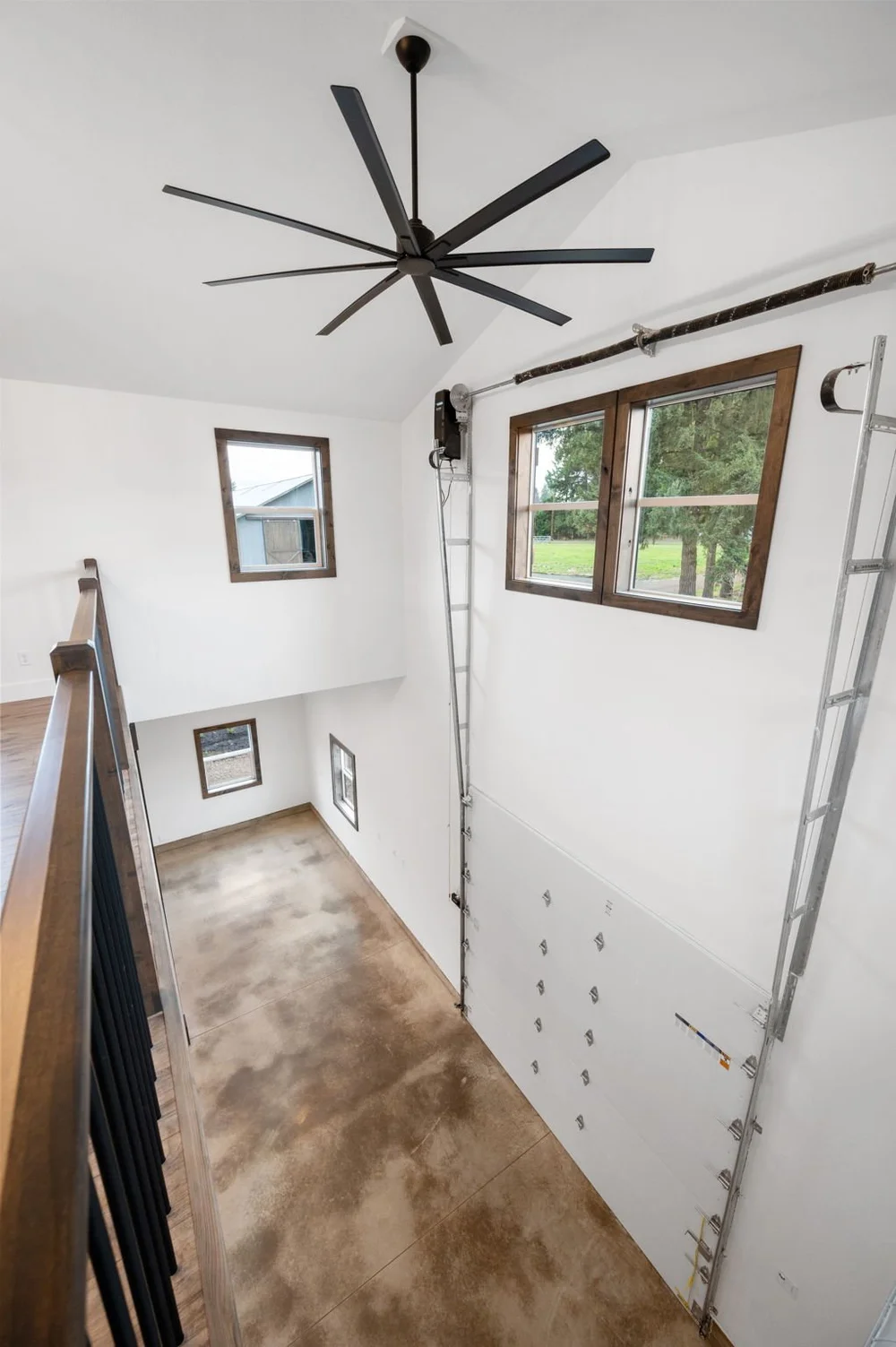 View from the loft down into the main-floor space beside the tall garage door.