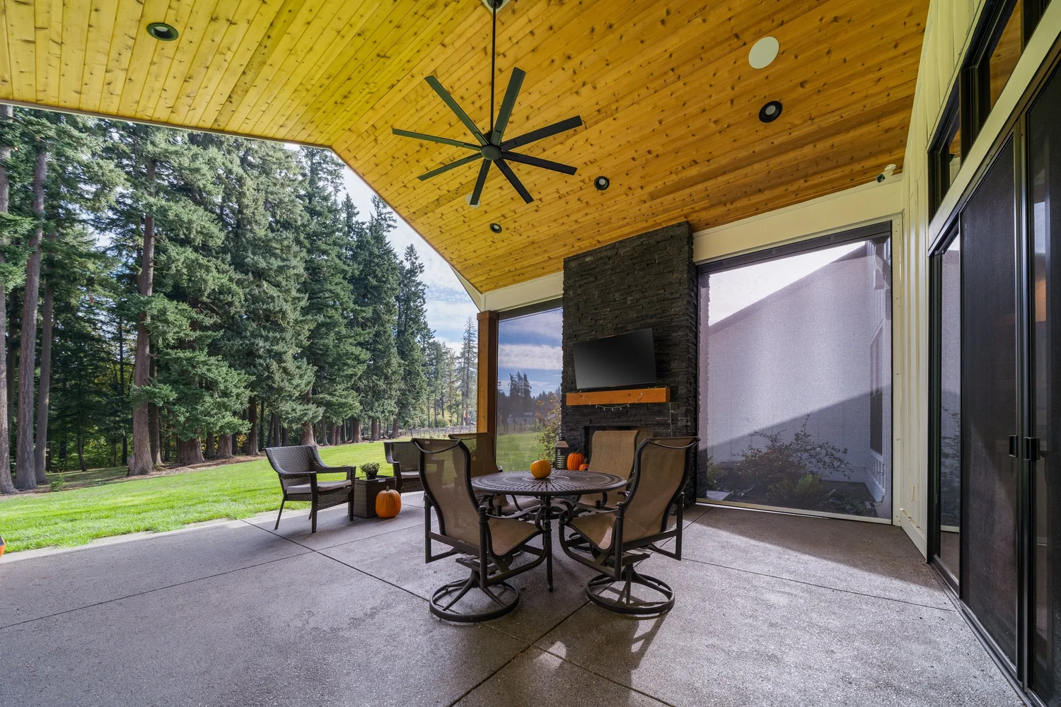 A covered patio beside the trees — Generations at Meridian.