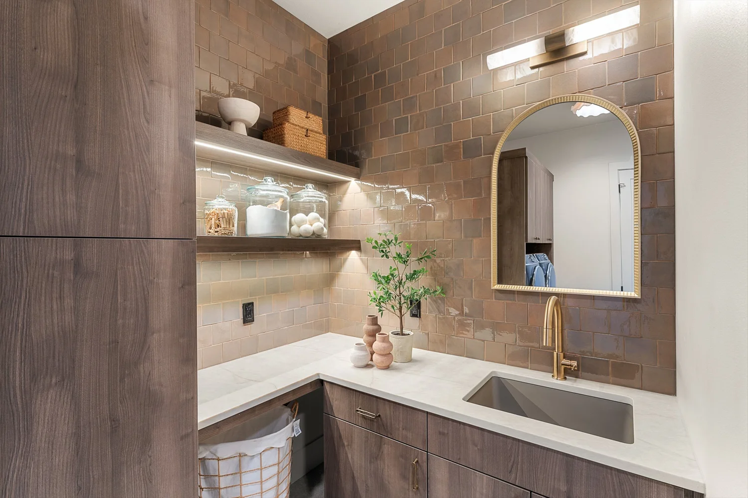 The laundry room sink and storage at 16067 Kaylyn Drive.
