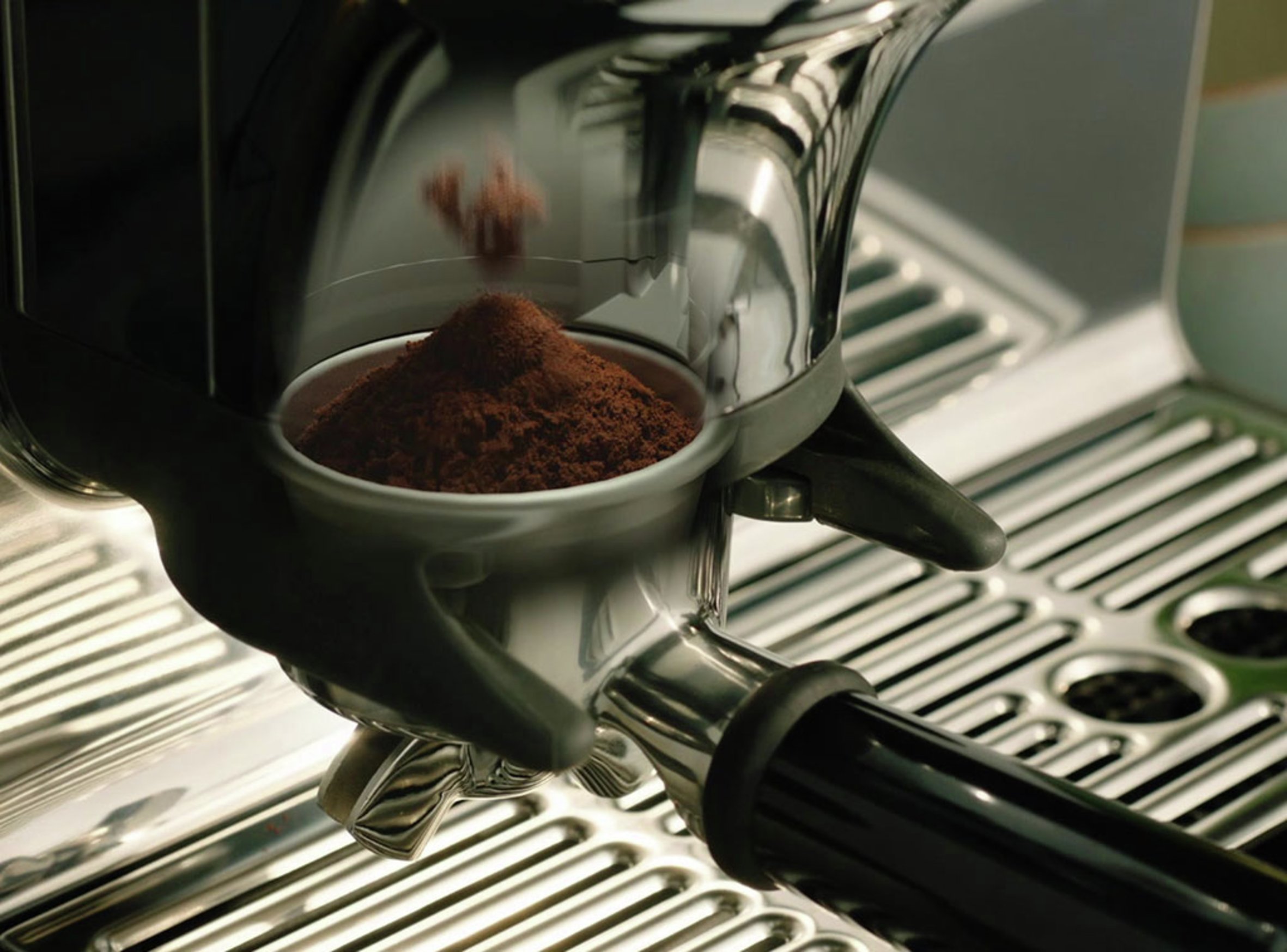 image of coffee grounds falling into portafilter