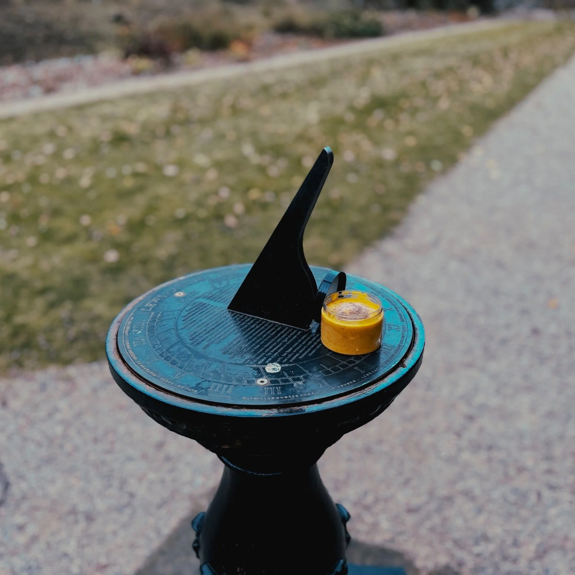 An ice cream atop a sundial.