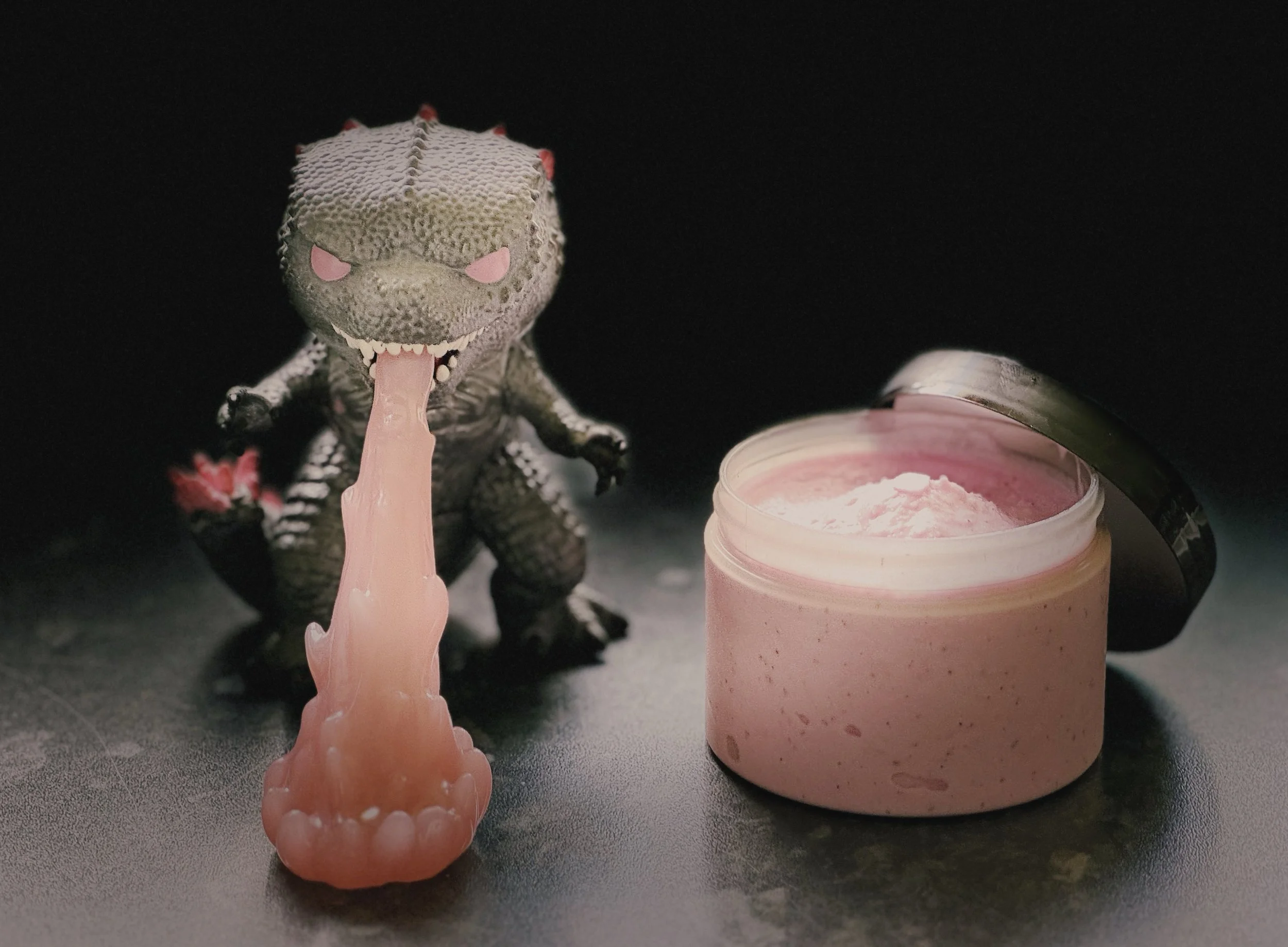 Evolved Godzilla funko pop next to a tub of atomic pink heat ray ice cream.
