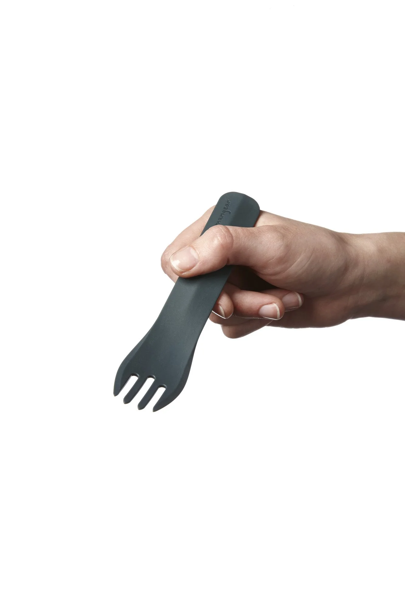 Hand holding a black reusable spork against a white background.