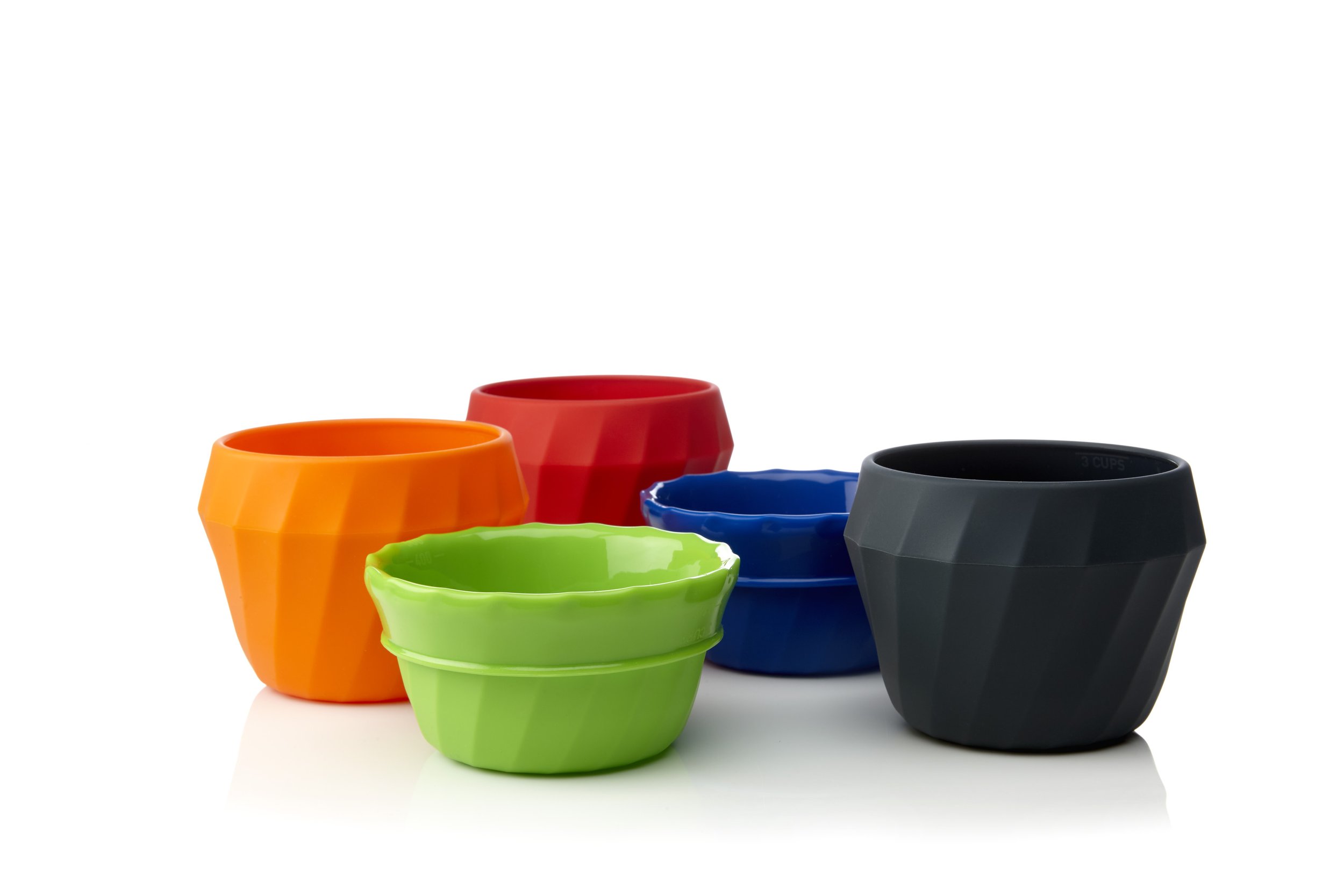Five colorful, geometric-shaped silicone cups in orange, red, green, blue, and black, arranged in a group on a white background.