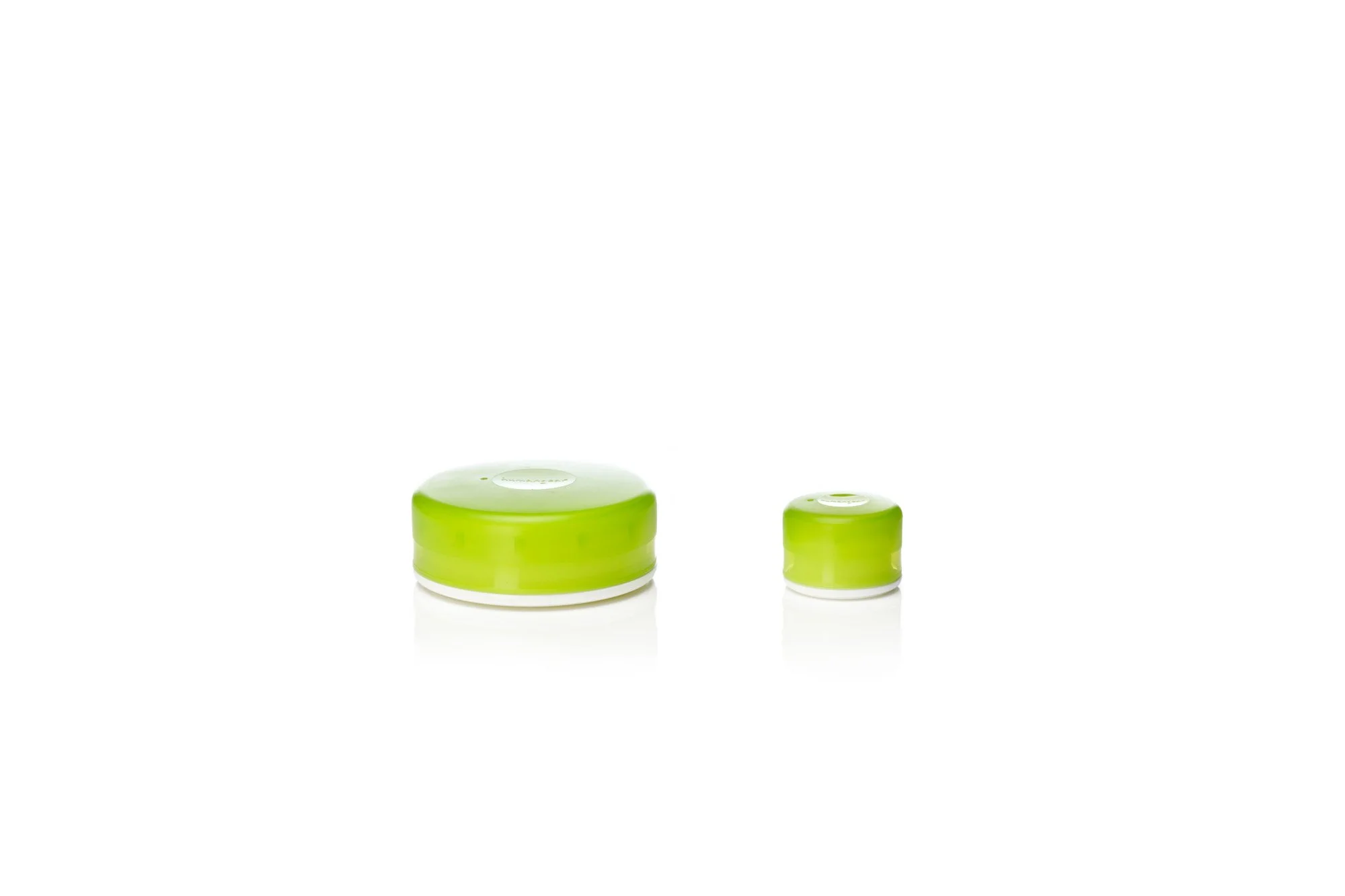 Two green cylindrical containers, one larger and one smaller, on a white background.