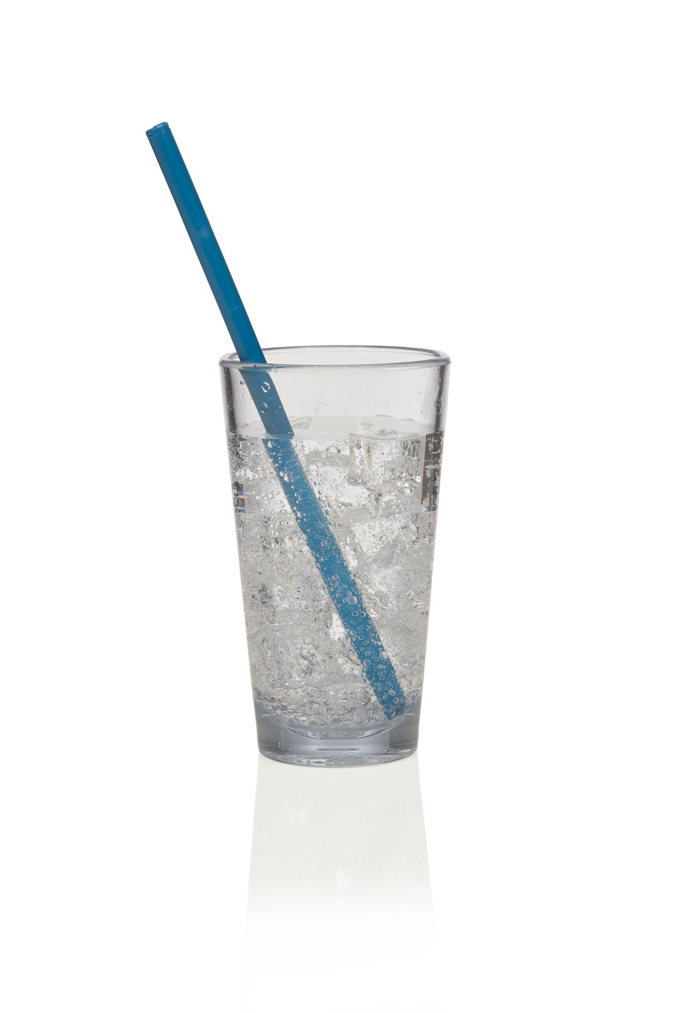 Glass of sparkling water with ice cubes and a blue straw