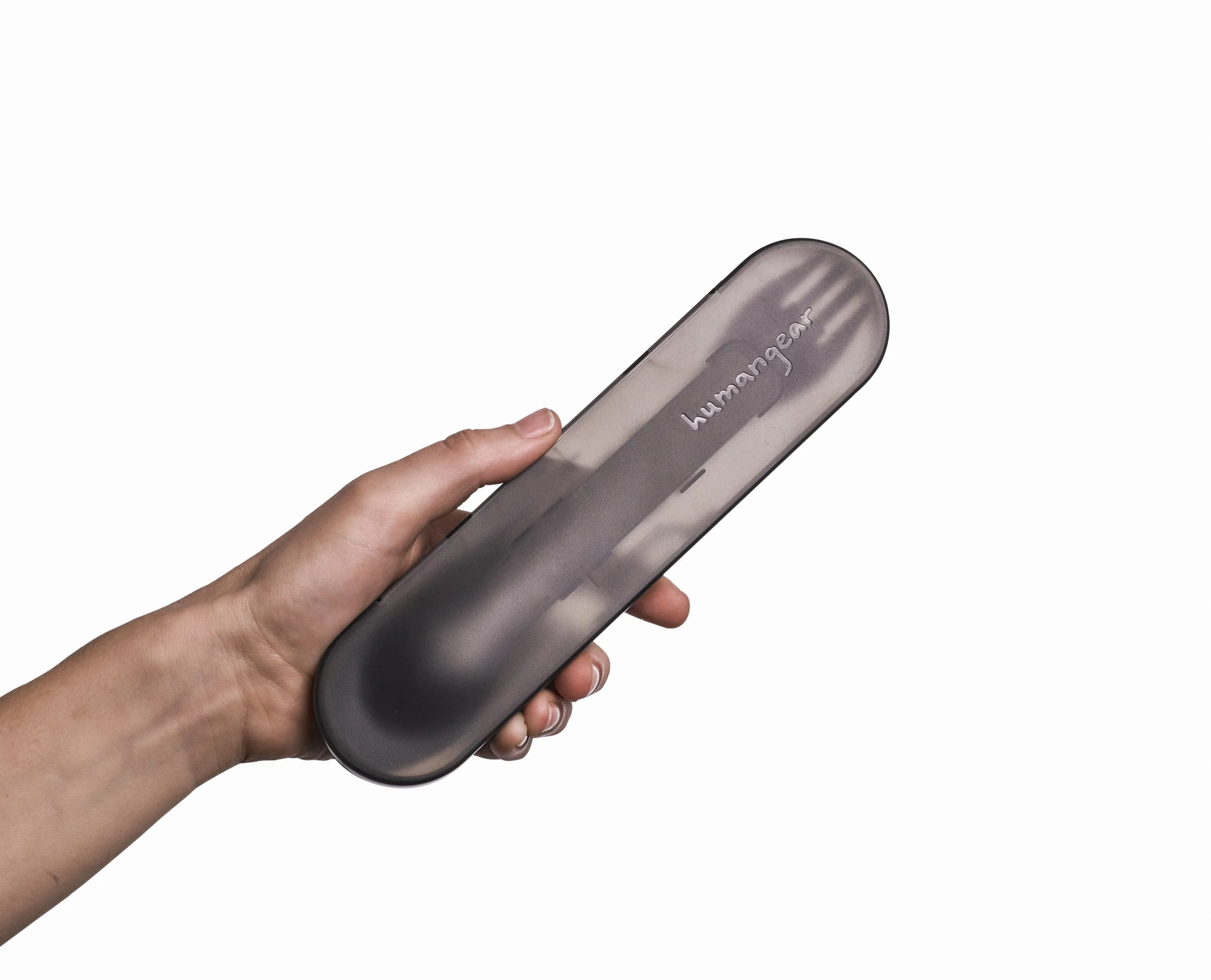 Hand holding a black case labeled humangear containing utensils.