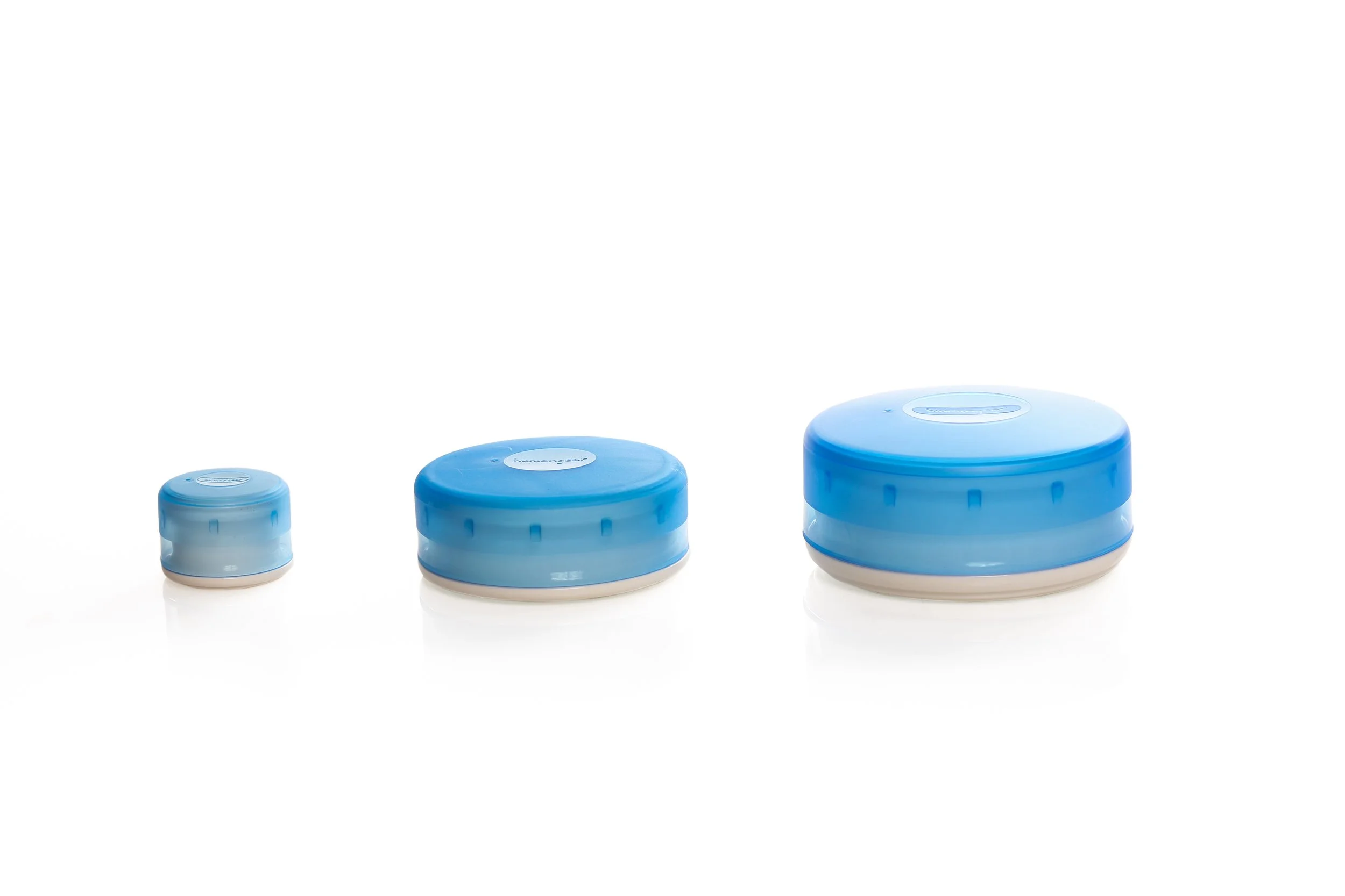 Three blue round storage containers in different sizes on a white background.