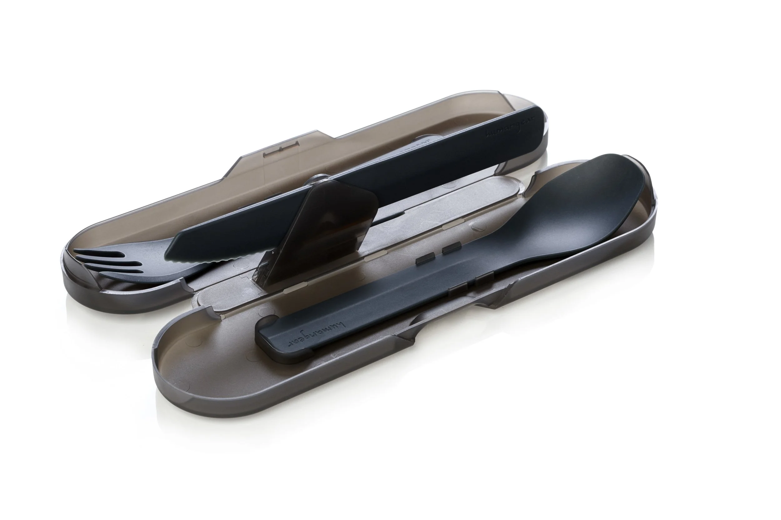 Portable cutlery set with black spork and knife in a transparent gray case, designed for travel or camping.