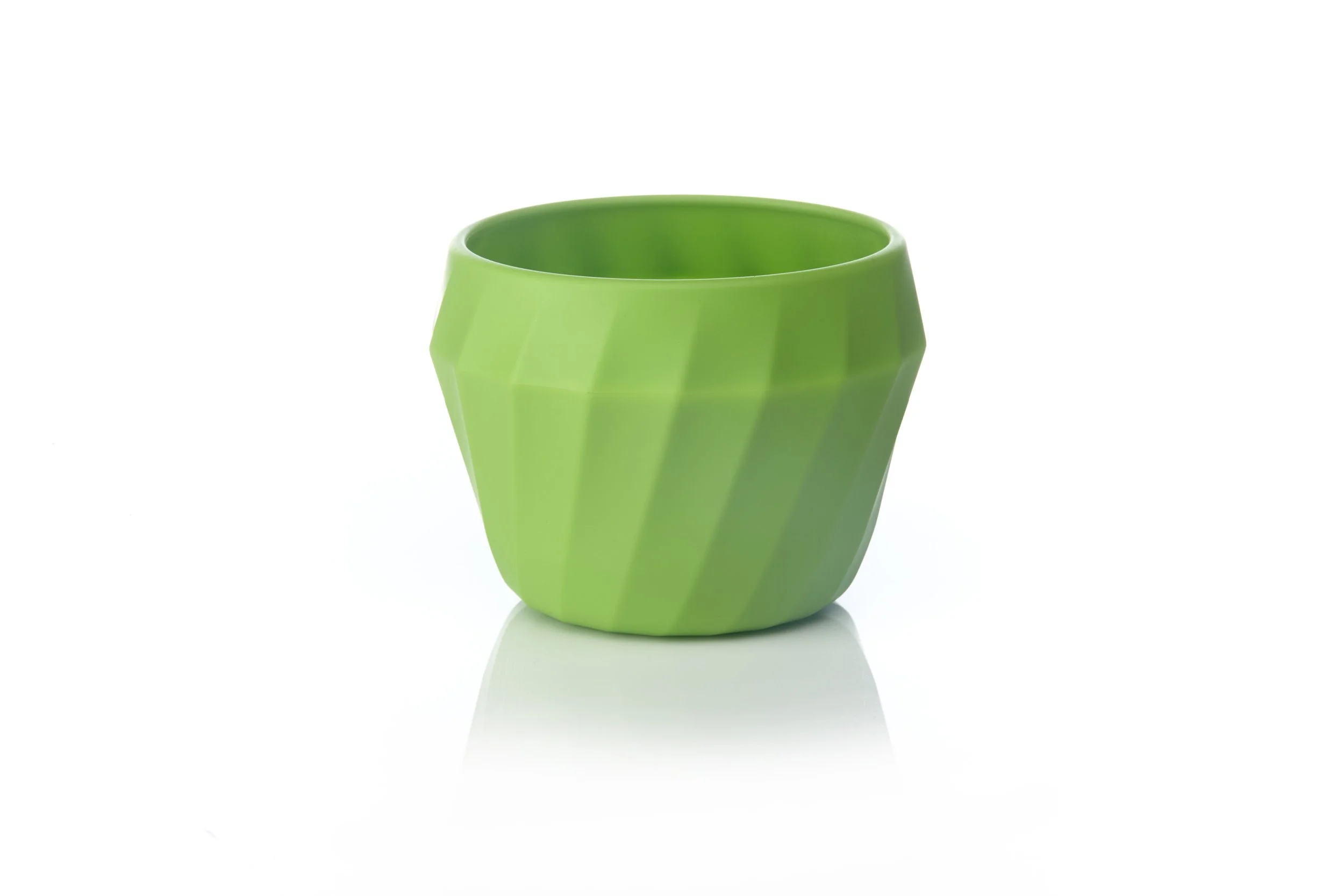 Green faceted plastic cup against a white background.