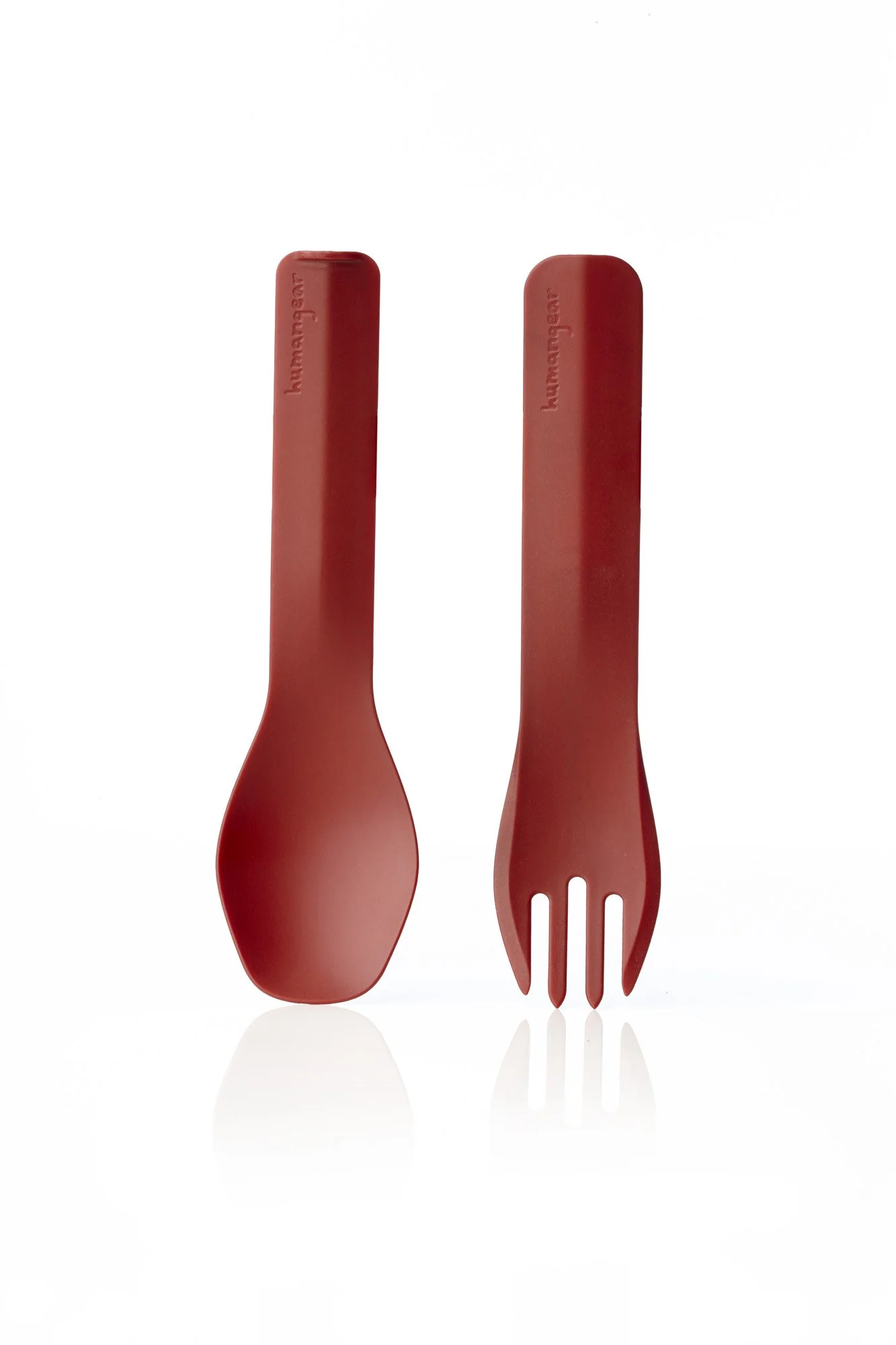 Red plastic spork and utensil with a smooth handle.
