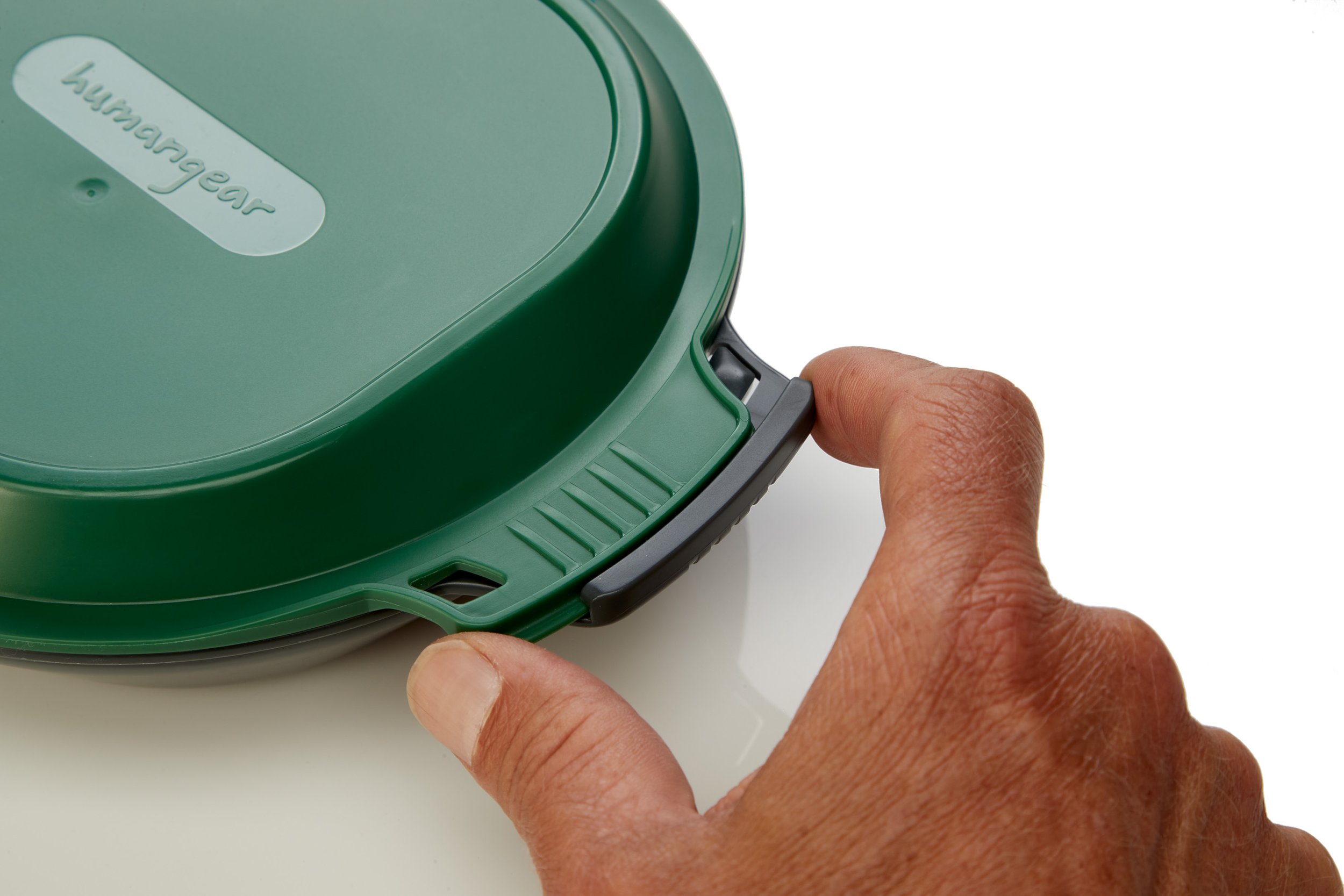 Person holding a green Humangear GoBites container lid