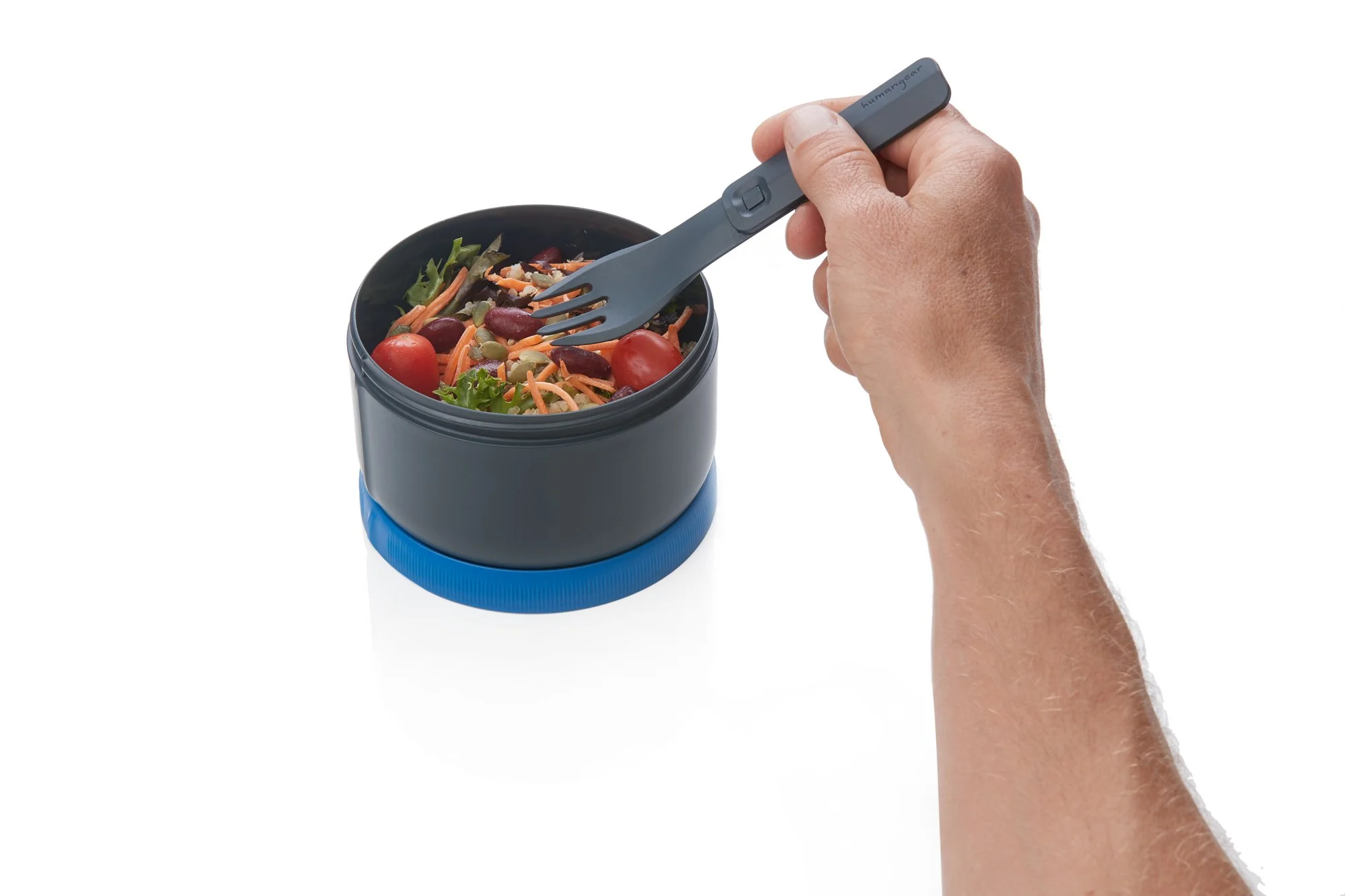 Person holding a spork over a bowl of salad with cherry tomatoes, kidney beans, and mixed greens.
