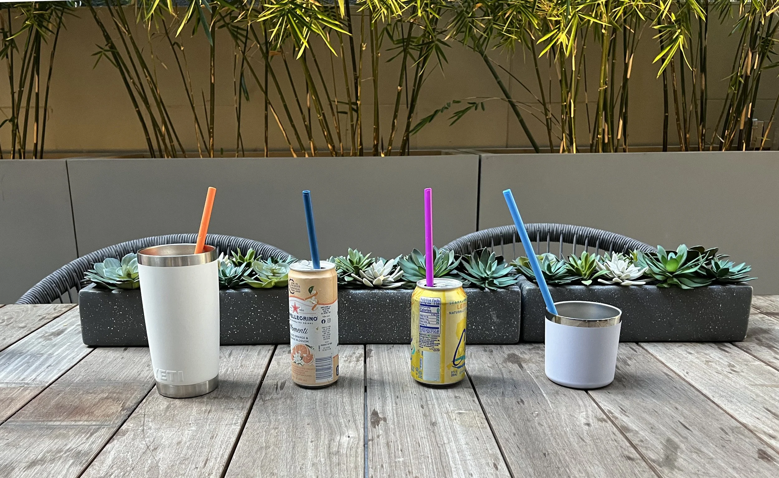 Outdoor table with beverages and straws
