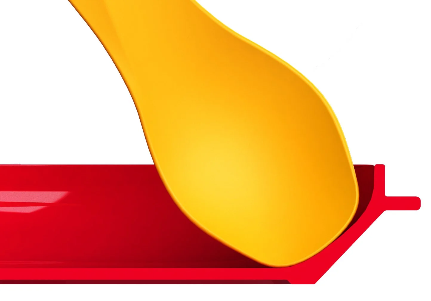 Close-up of a yellow spoon resting on a red tray.