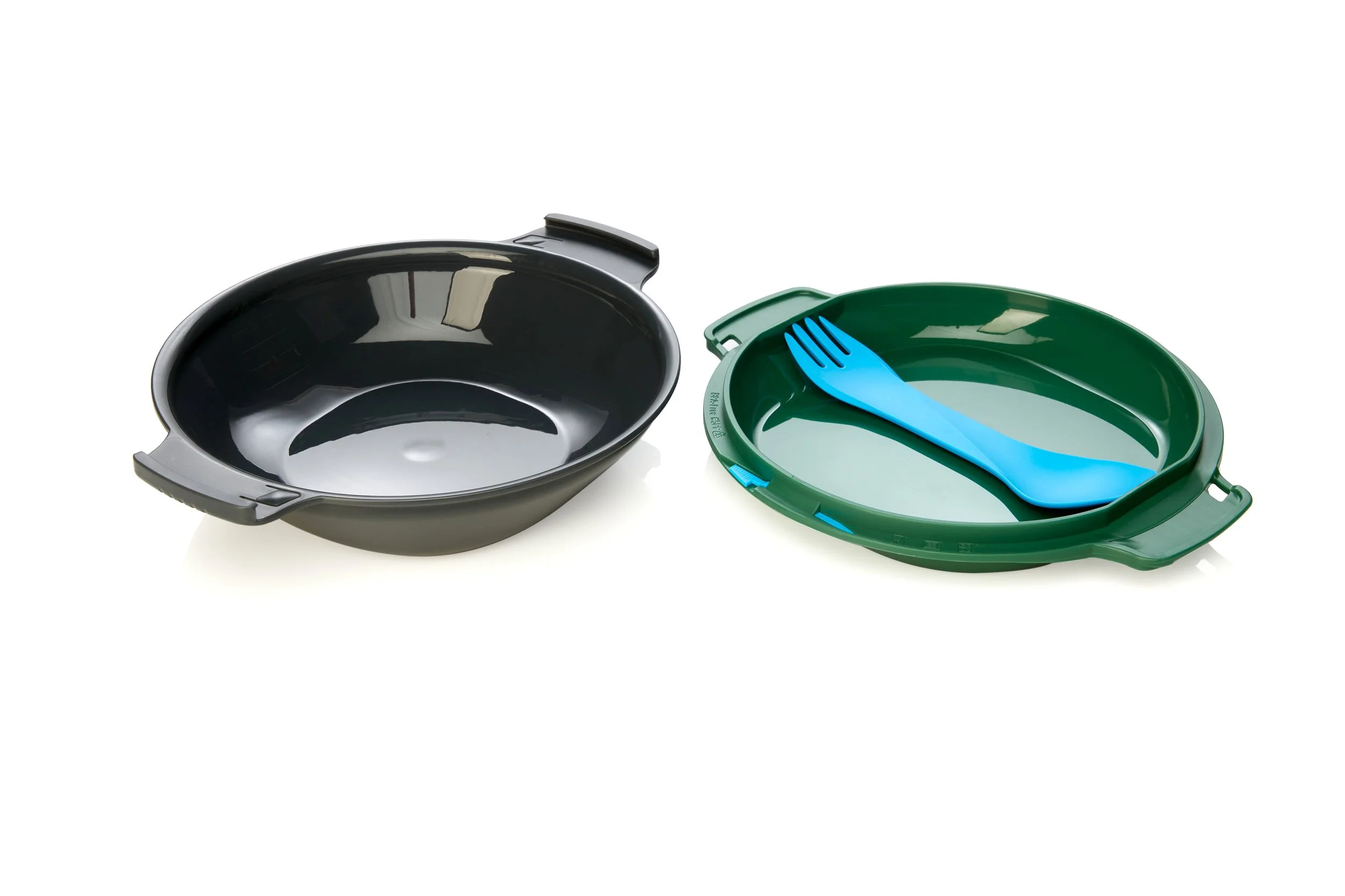 Two stackable plastic containers, one black and one green, with a blue spork inside the green container on a white background.