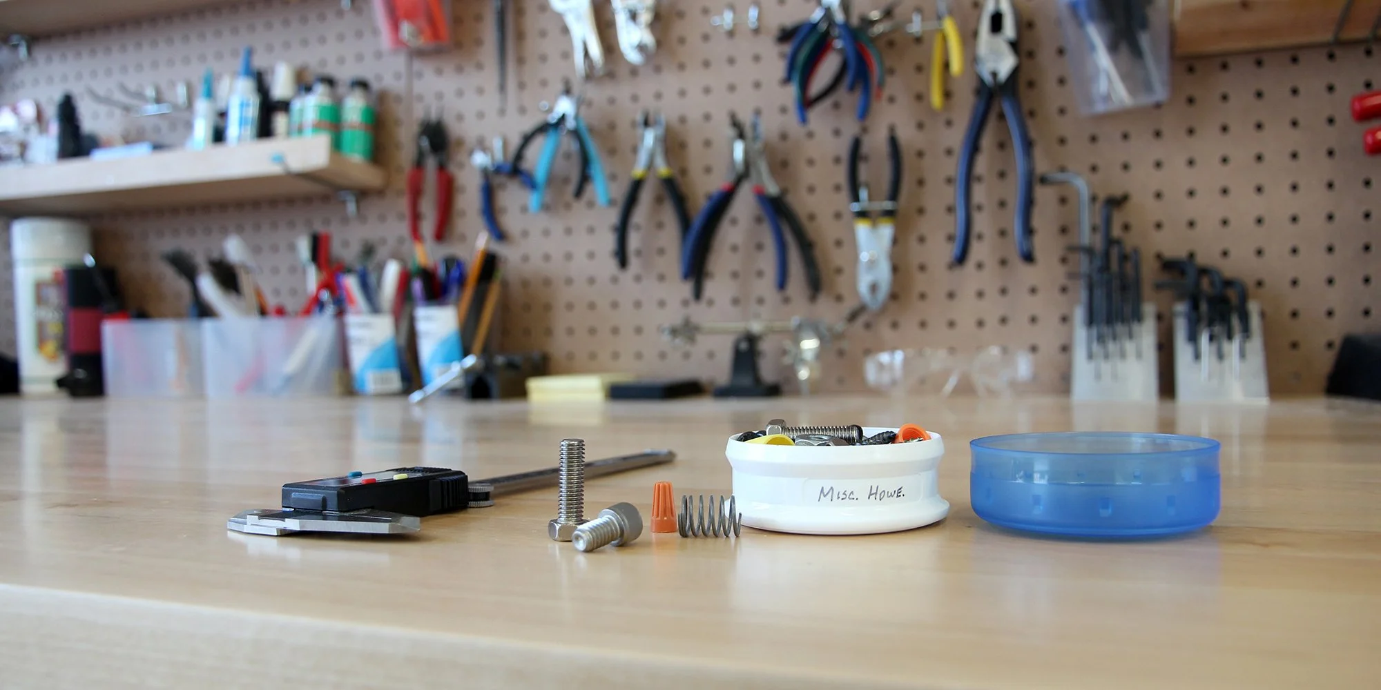workshop with tools, hardware pieces, and organized shelves