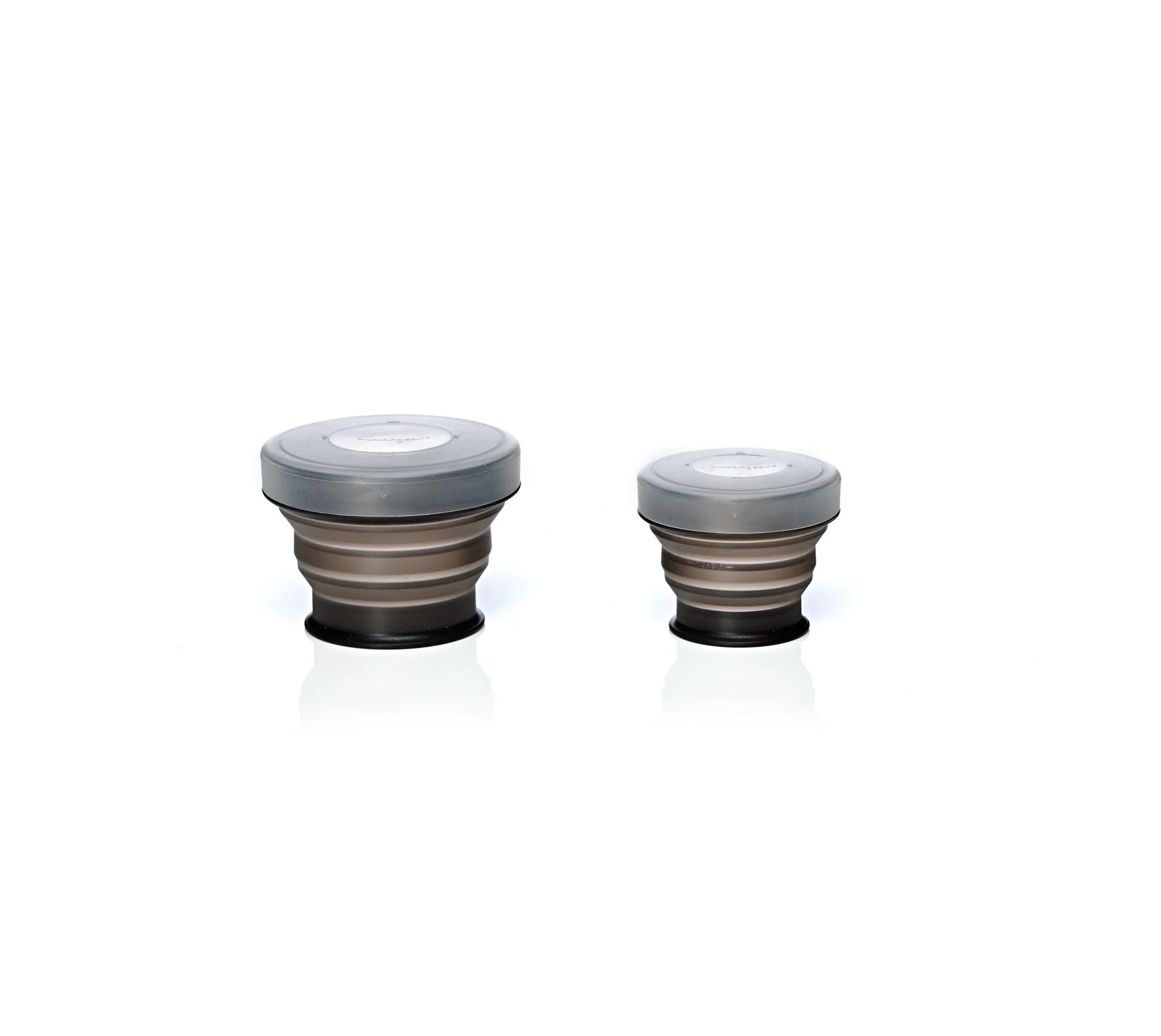 Two collapsible containers with lids on a white background
