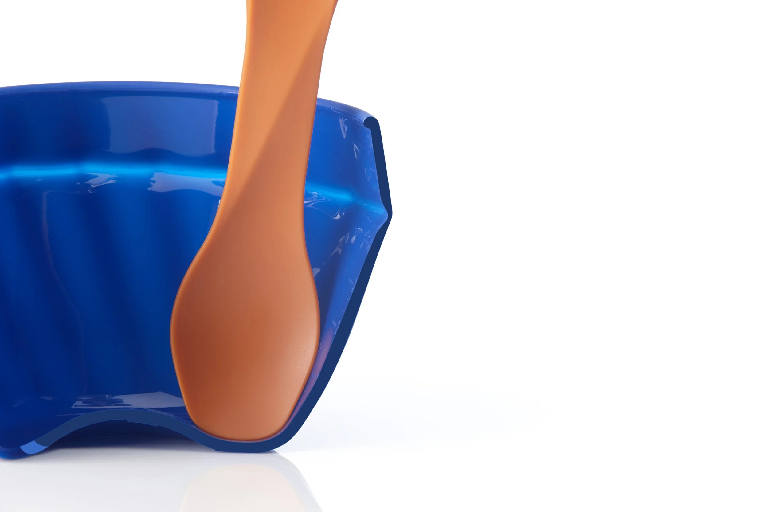 Close-up of an orange spoon in a blue bowl.