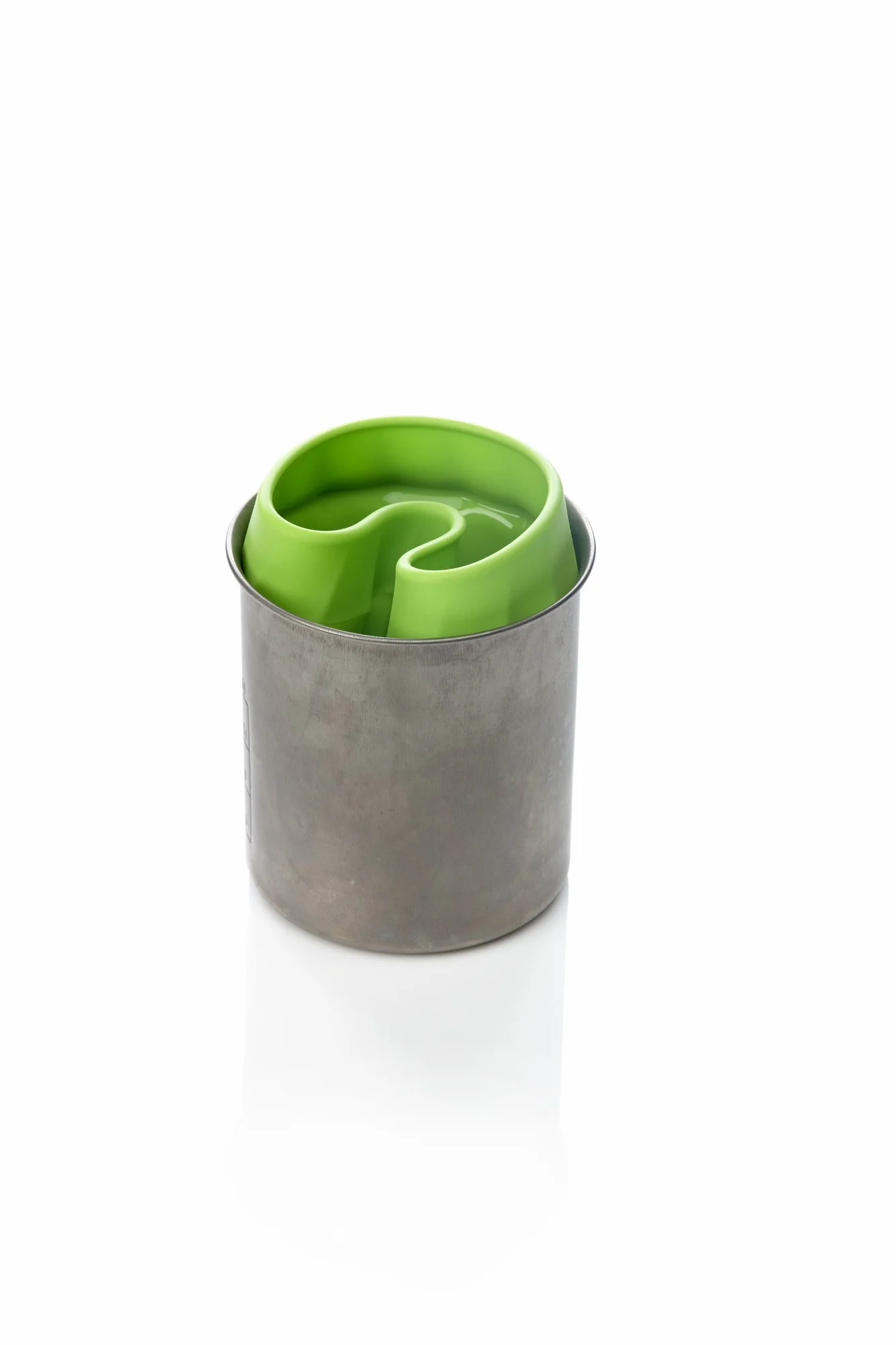 Green silicone ice mold in a metal cup