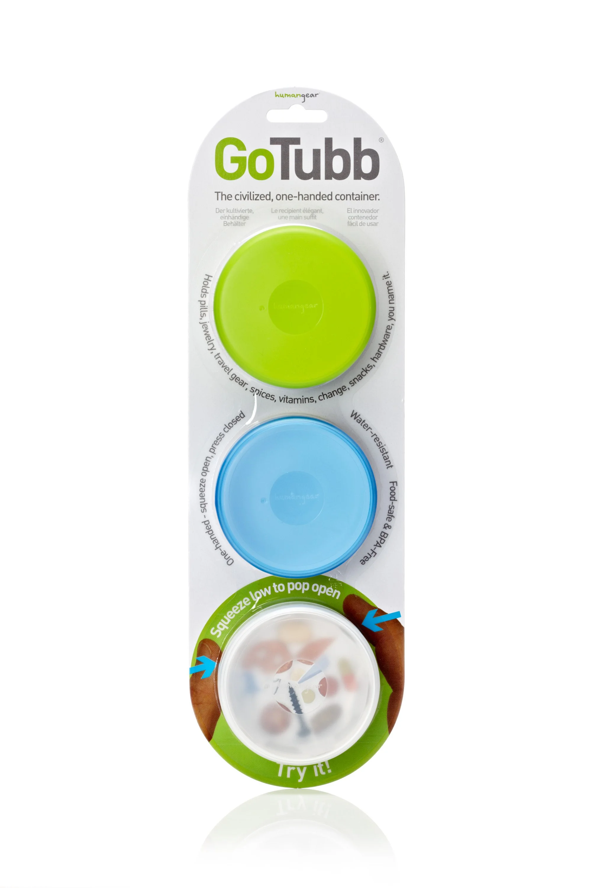 GoTubb containers package with three plastic containers in green, blue, and clear colors. Product is marketed as a one-handed, easy-access storage solution for pills, jewelry, and other small items. Includes a "squeeze low to pop open" instruction.