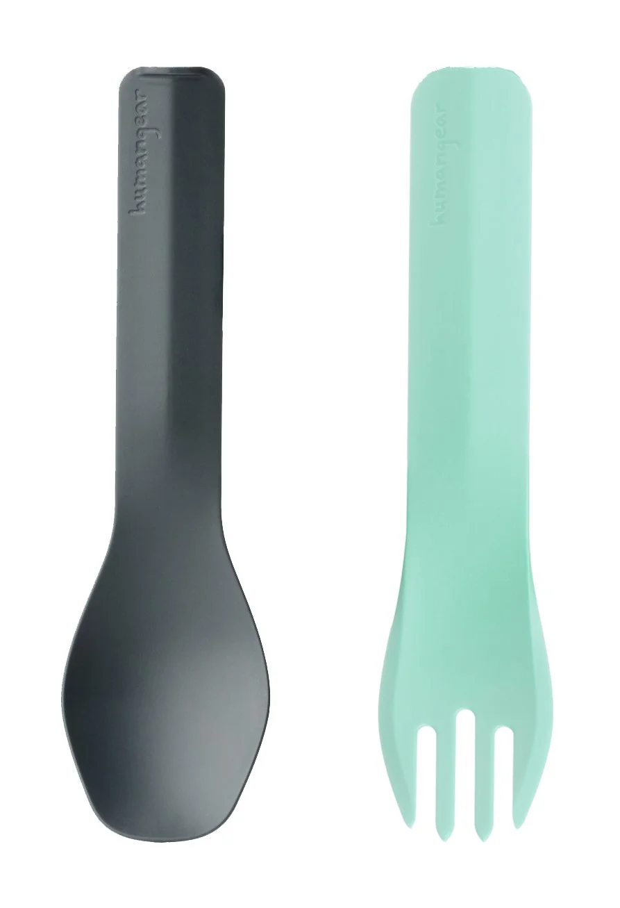 Two plastic utensil cases, one gray and one green, with the brand name "humangear" embossed on each.