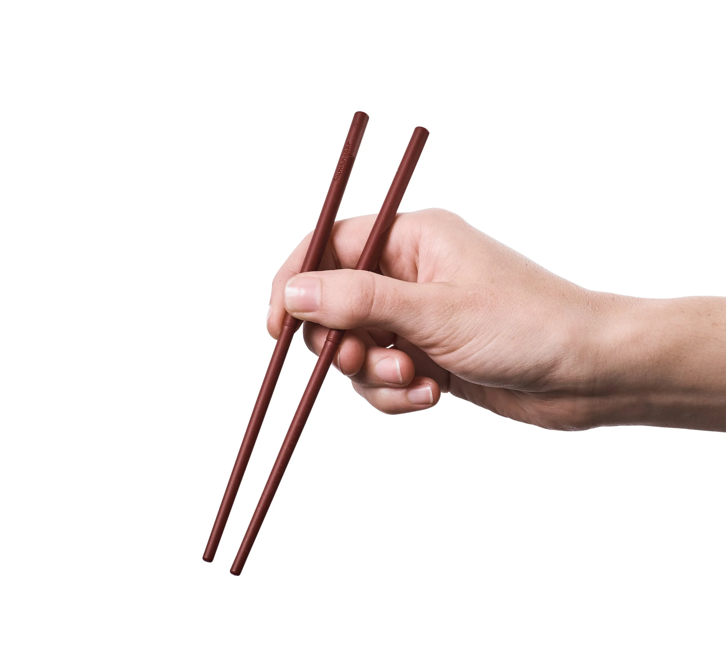 Hand holding two brown chopsticks against a white background.