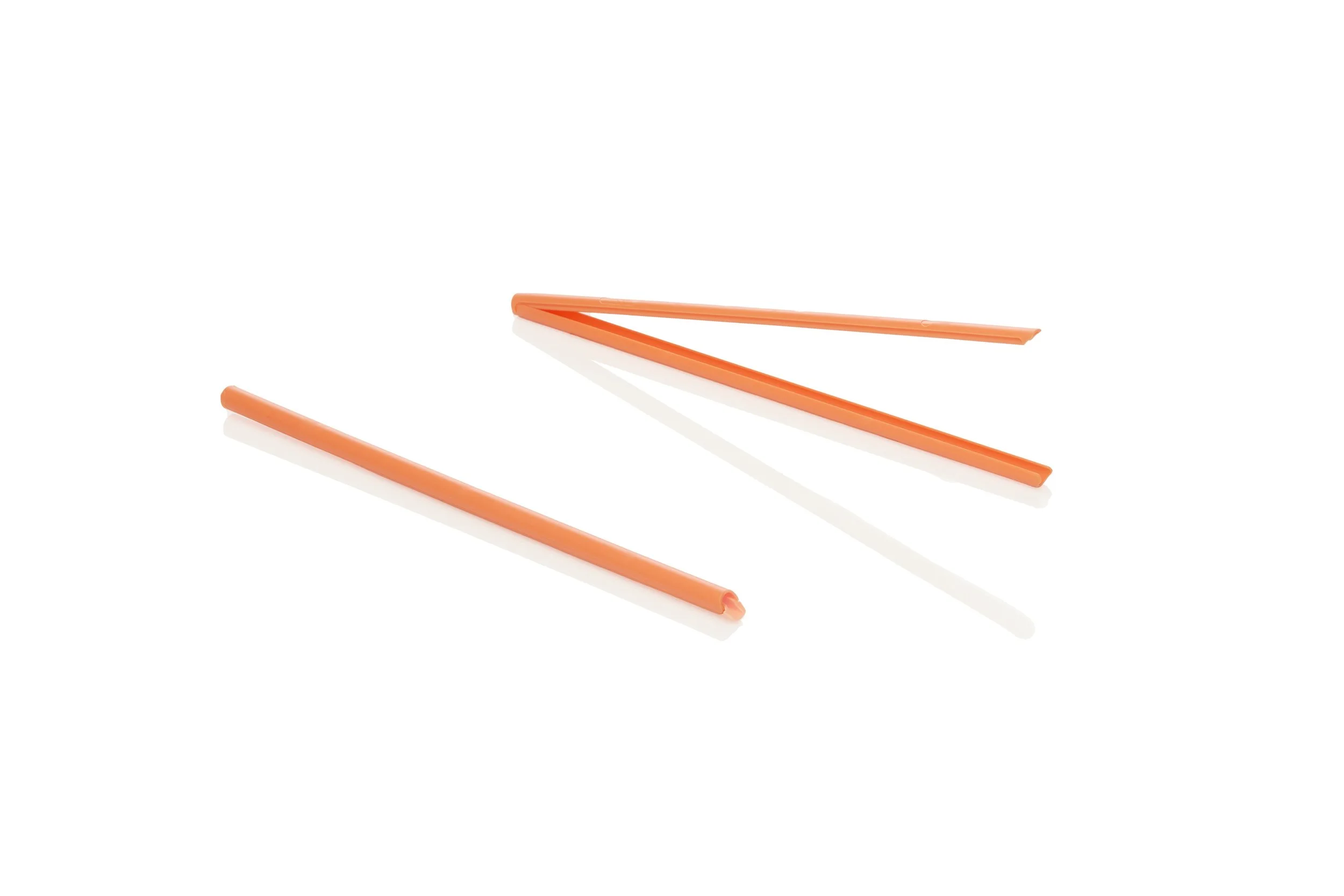 Two pair of orange chopsticks on a white background, one pair separated apart.