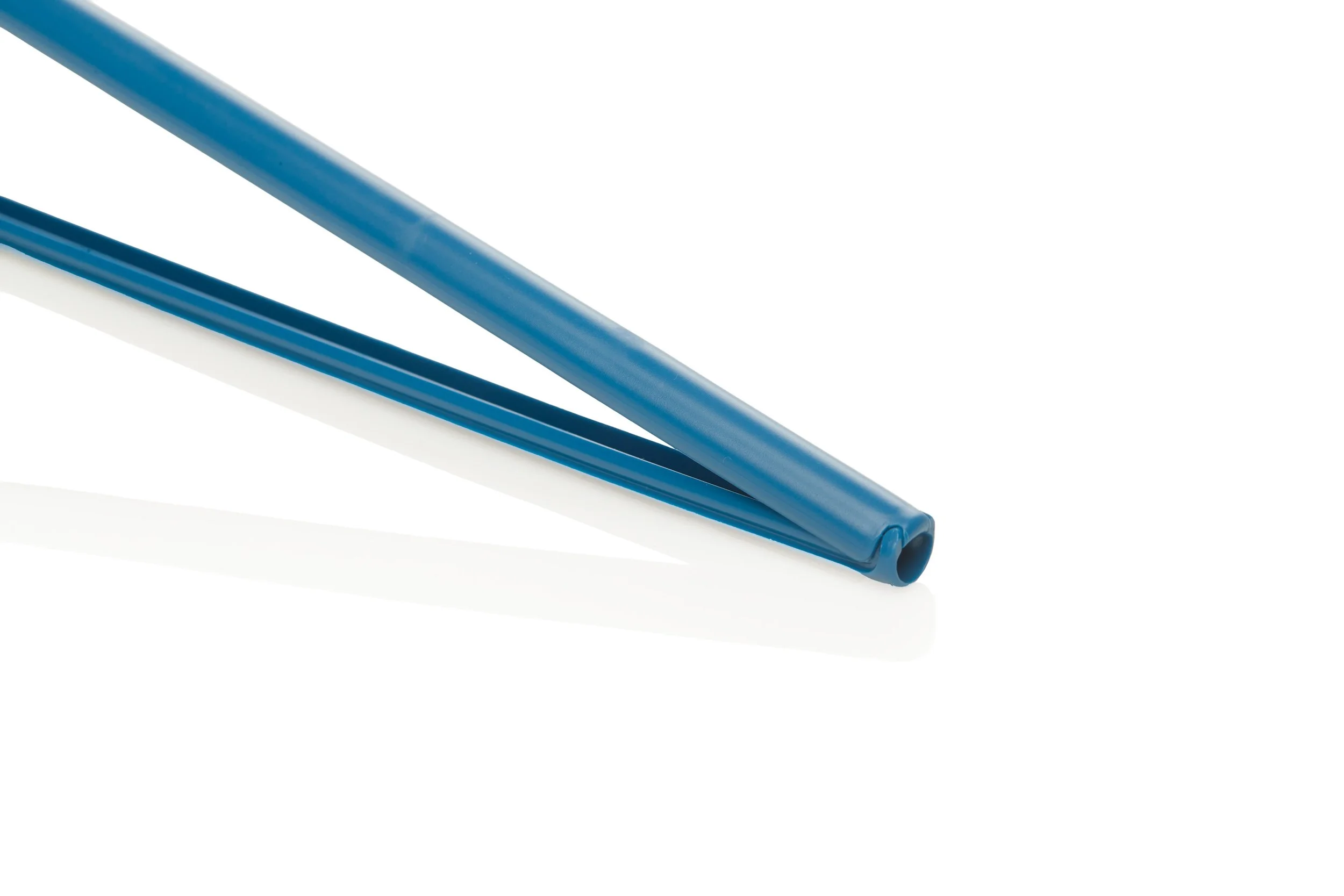 Close-up of blue plastic chopsticks on a white background