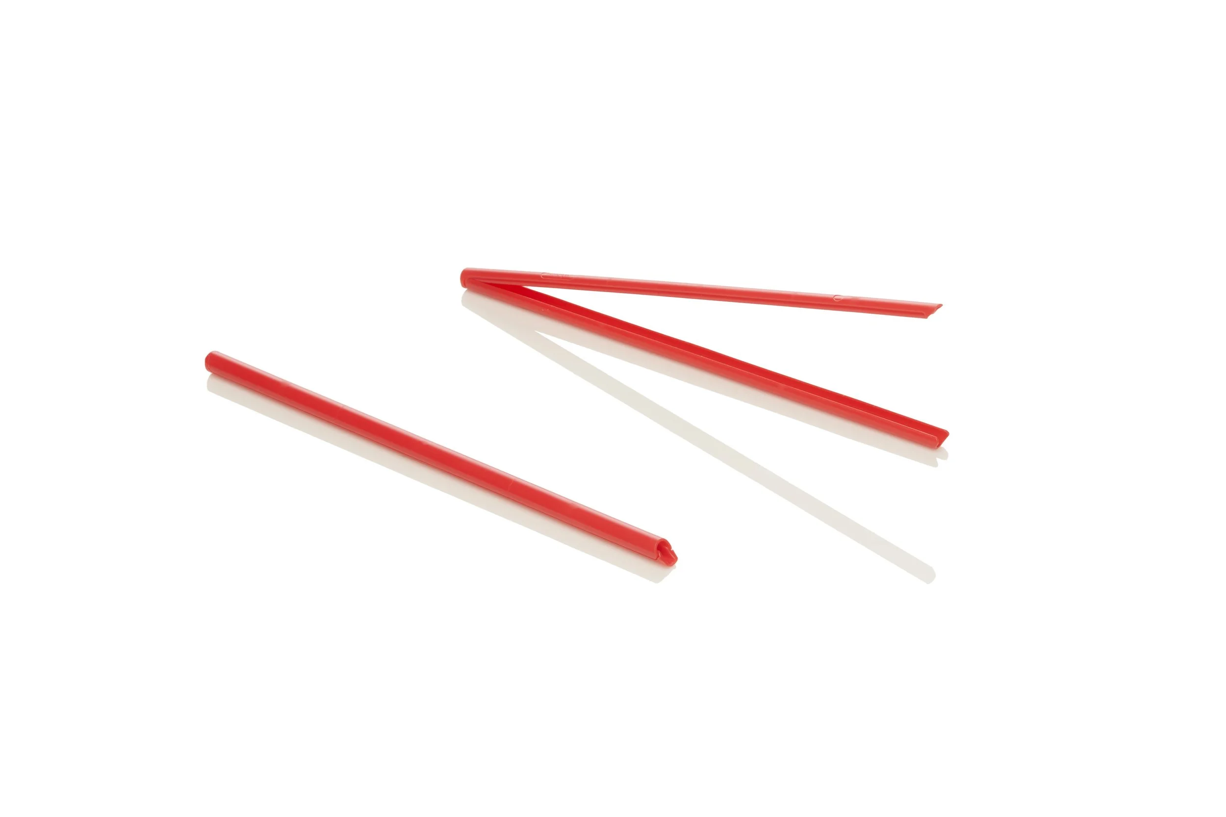 Three red plastic straws arranged on a white background.