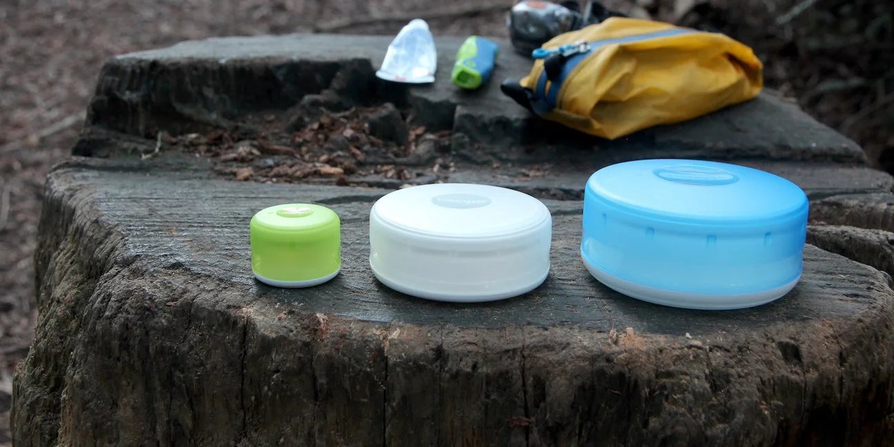 3 GoTubb containers on a log