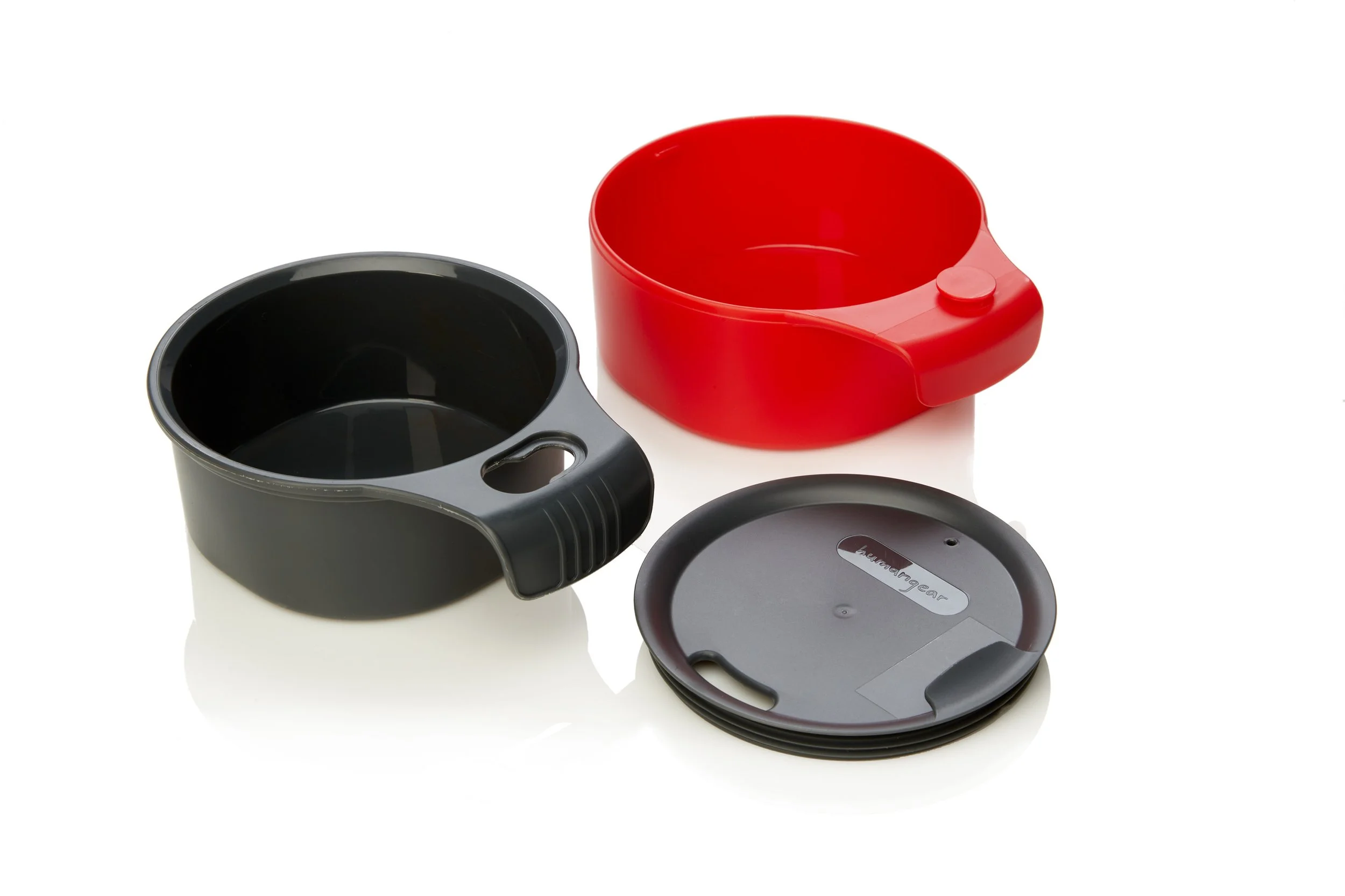 Two plastic measuring cups, one black and one red, with a black lid on a white background.
