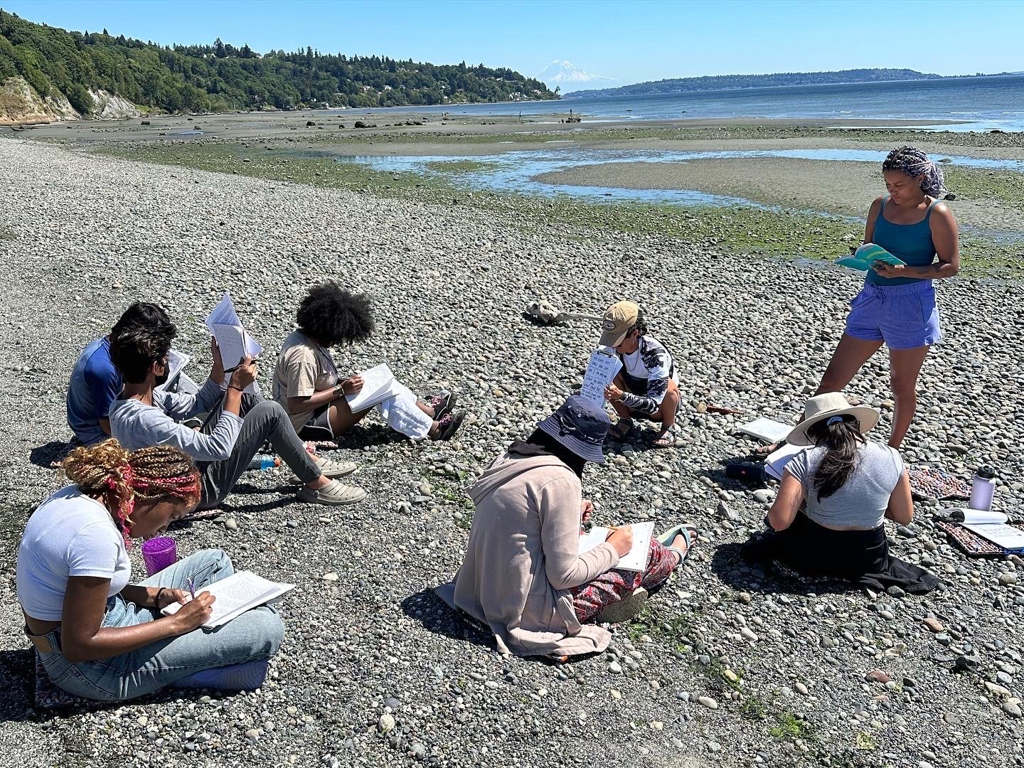 Between The Tides Summer 2023 cohort doing a guided journaling activity at Discovery Park Beach