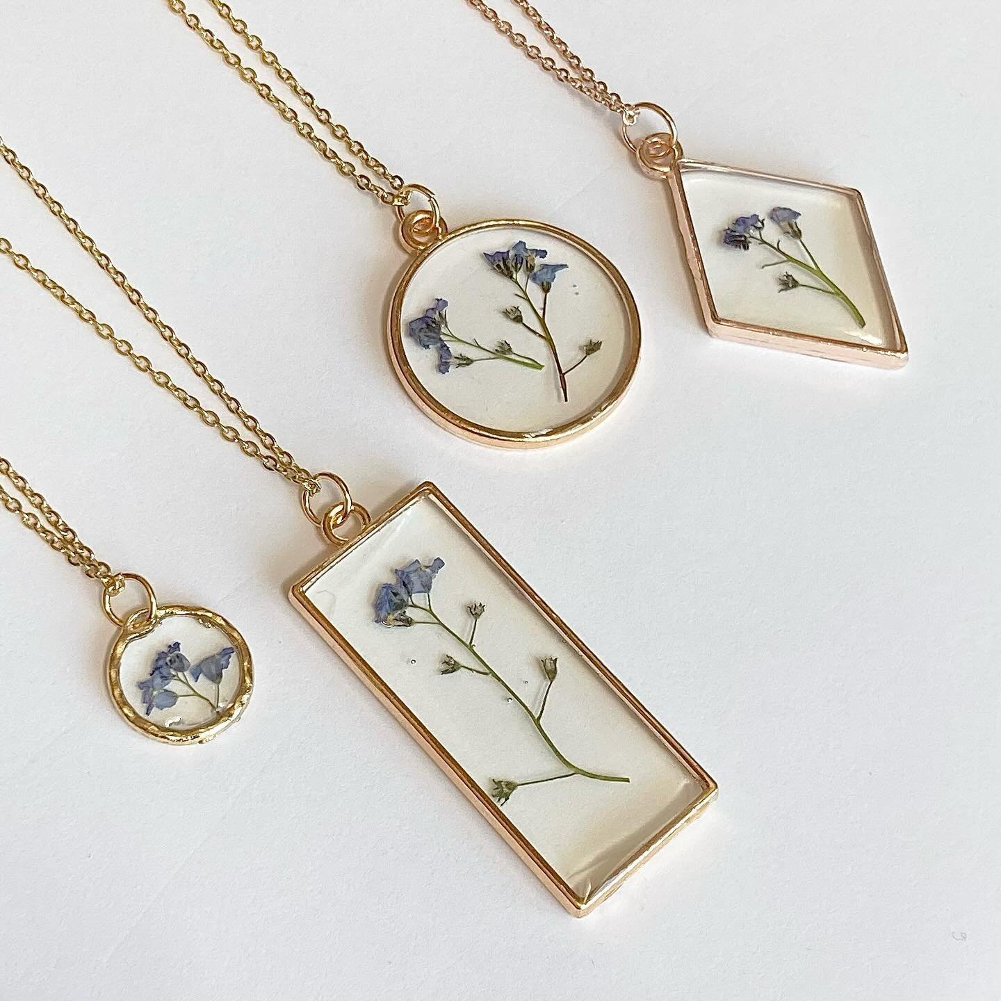 A variety of necklaces! Which style would you pick&mdash;forget-me-nots, buttercups, white florals on black resin, or antique? 

🐝 take a piece of the Berkshires with you 🐝 
.
.
.
.
.
.
.
.
.

#pressedflowers  #jewelryshop  #shopjewelry #jewelrysho