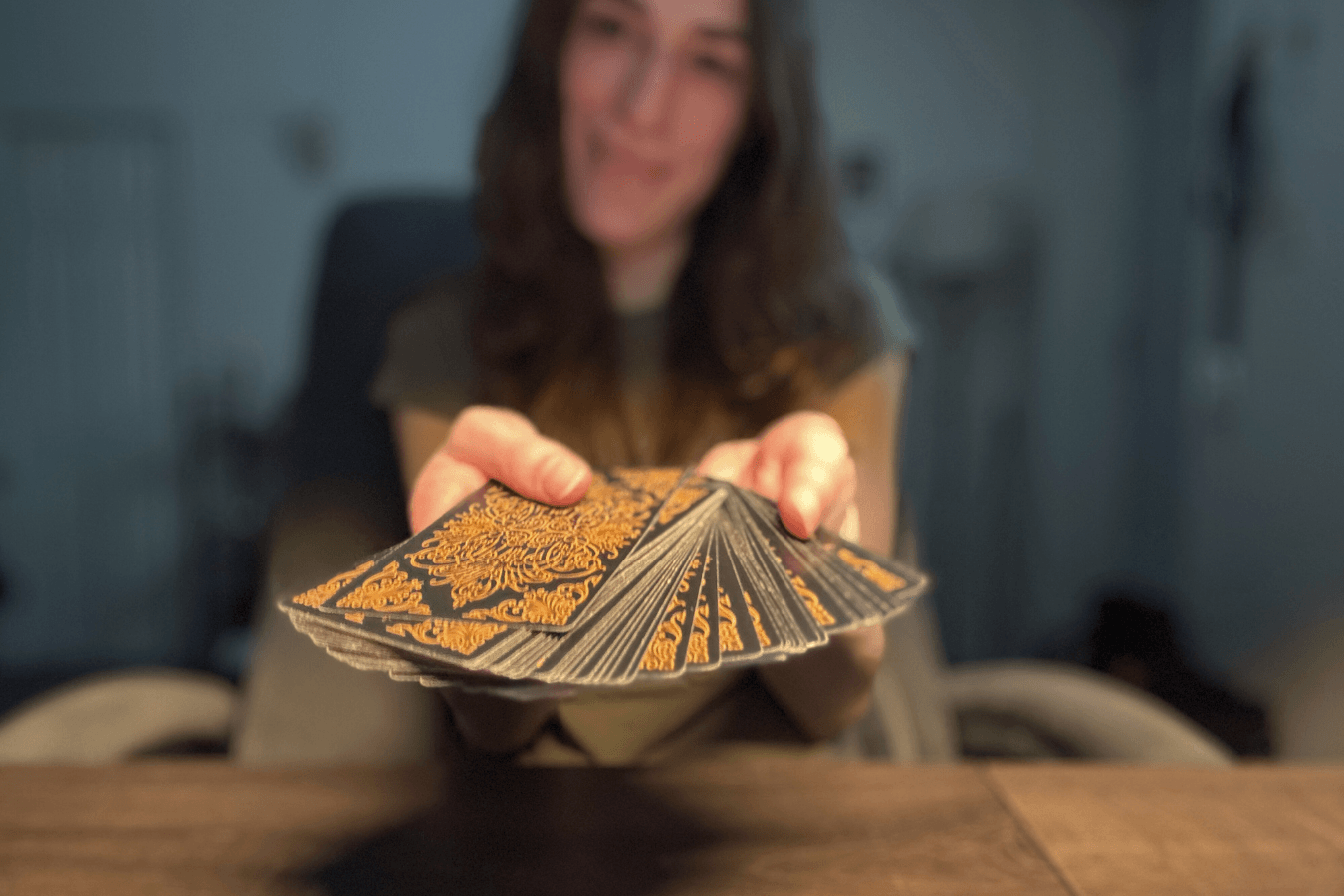 Ariel showing an oracle deck to the viewer