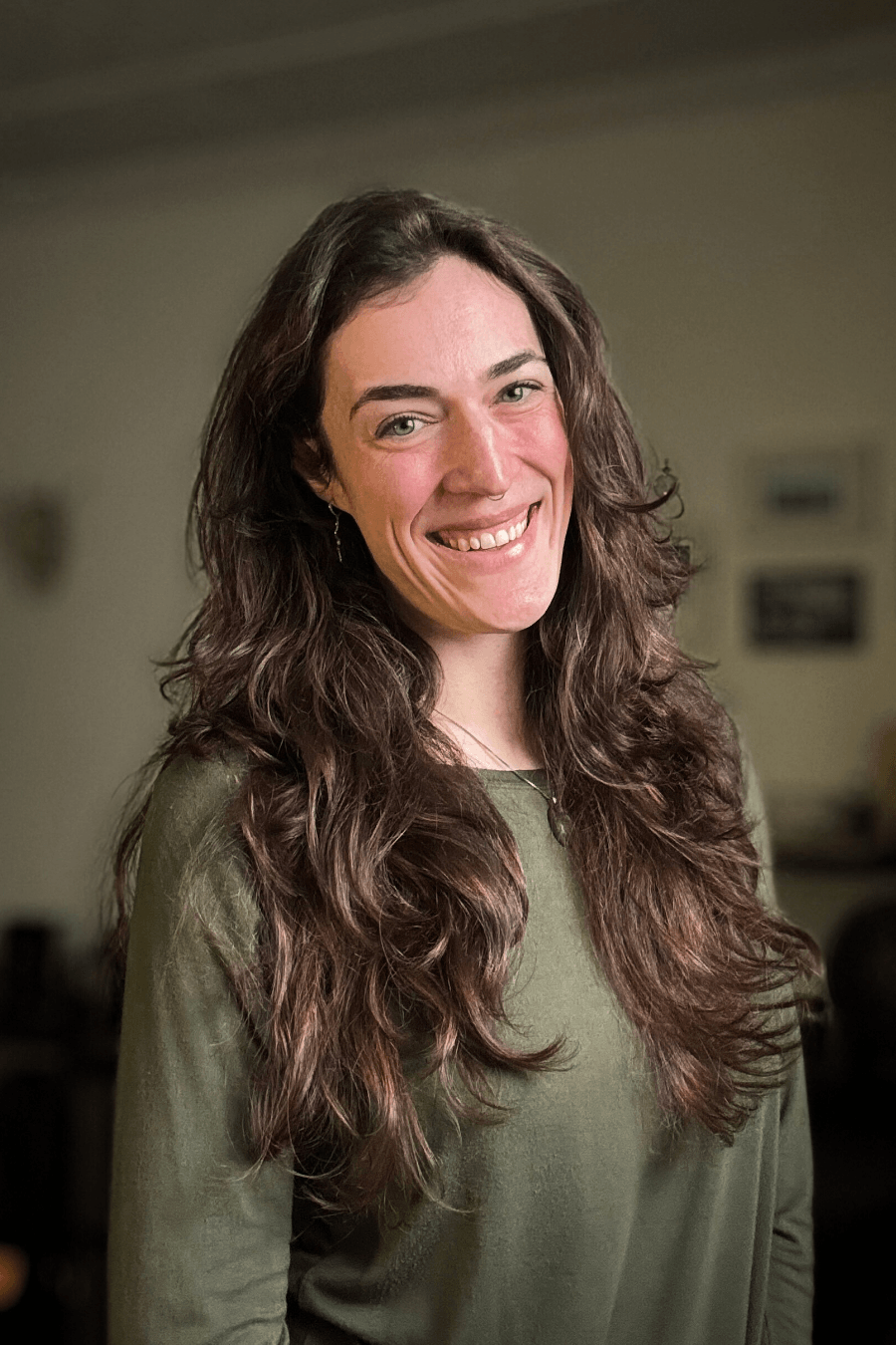 Ariel wearing a green shirt and smiling towards the viewer