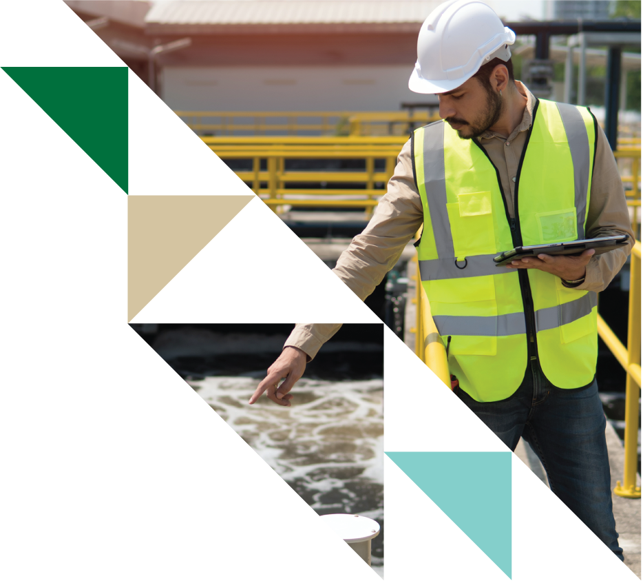 A man wearing a hard hat and a yellow safety vest inspecting a test sample at an industrial or construction site with yellow safety barriers in the background.