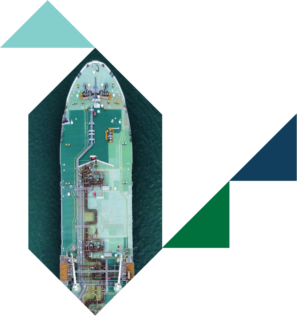 Top-down view of a large cargo ship with various pipes, machinery, and containers on the deck, surrounded by water.