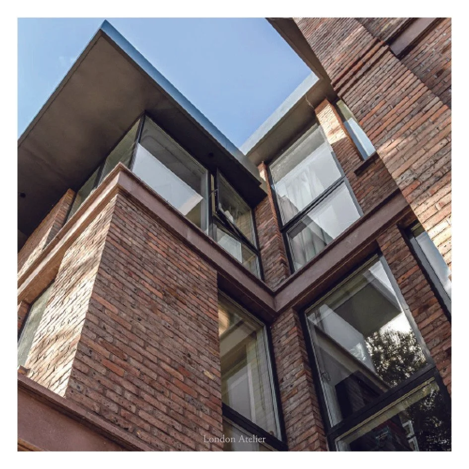 The front fa&ccedil;ade is defined by horizontal cast-stone bands that mark each storey with a measured rhythm. These refined concrete courses soften the vertical massing and introduce depth to the hand-made brickwork. Together they form a calm, cont