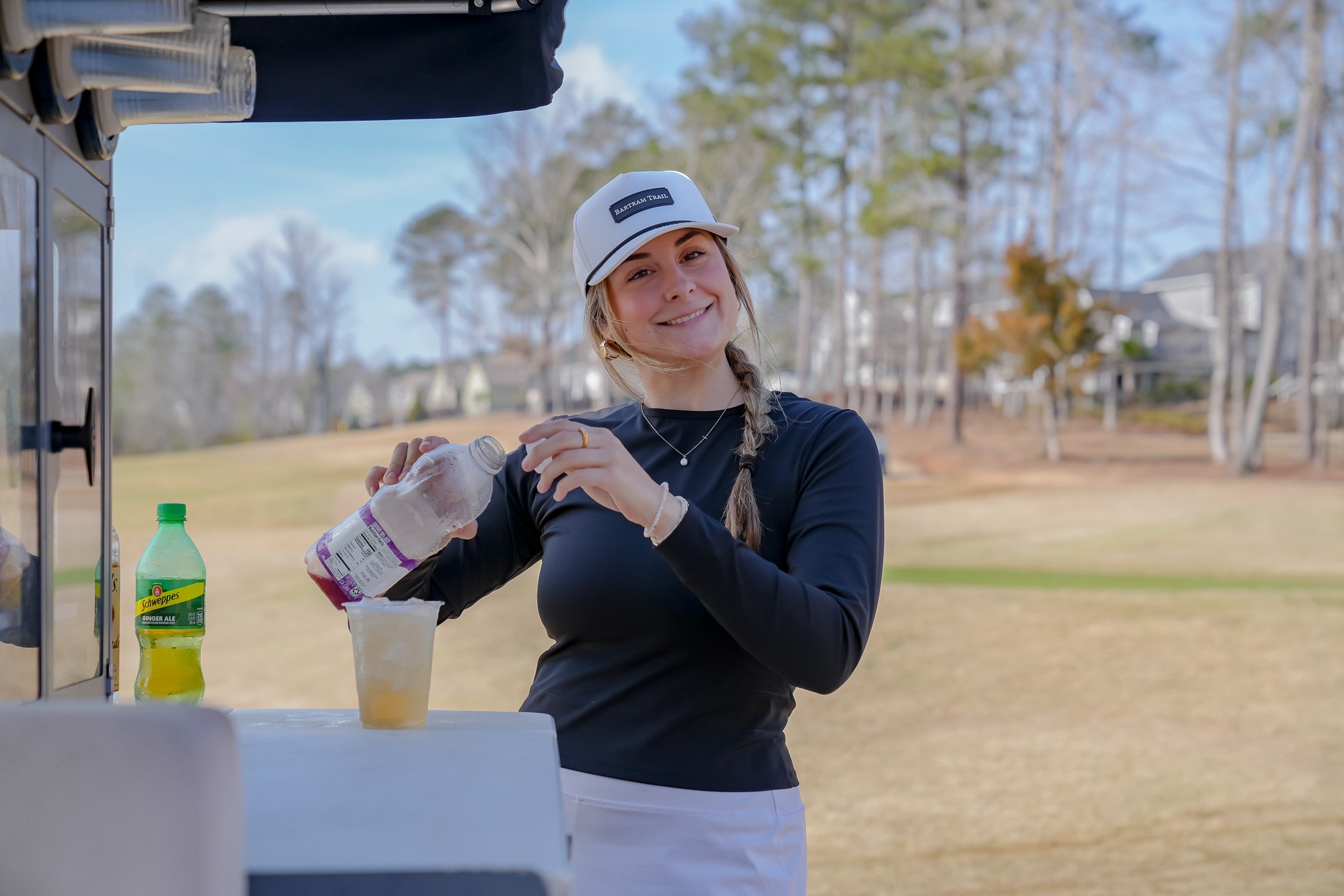 Beverage cart attendant serving drinks on the golf course at Bartram Trail Golf Club in Evans Georgia