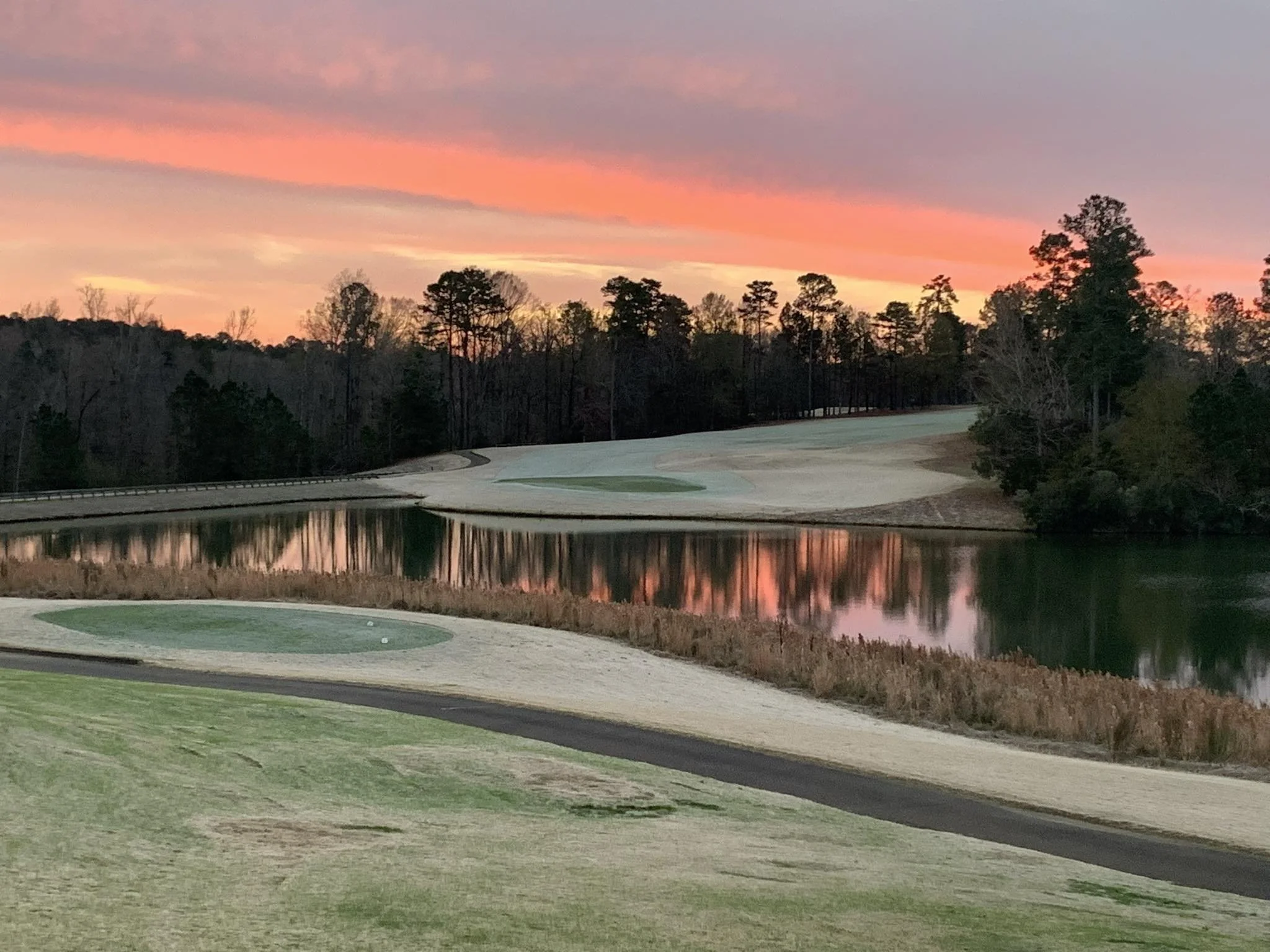 Sunset view over water hazard at Bartram Trail Golf Club public course in Evans Georgia near Augusta National