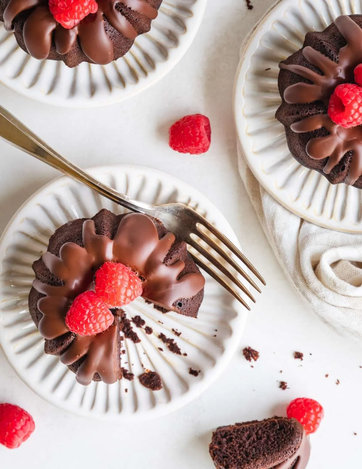 vegan chocolate bundt cakes on a plate with fresh berries