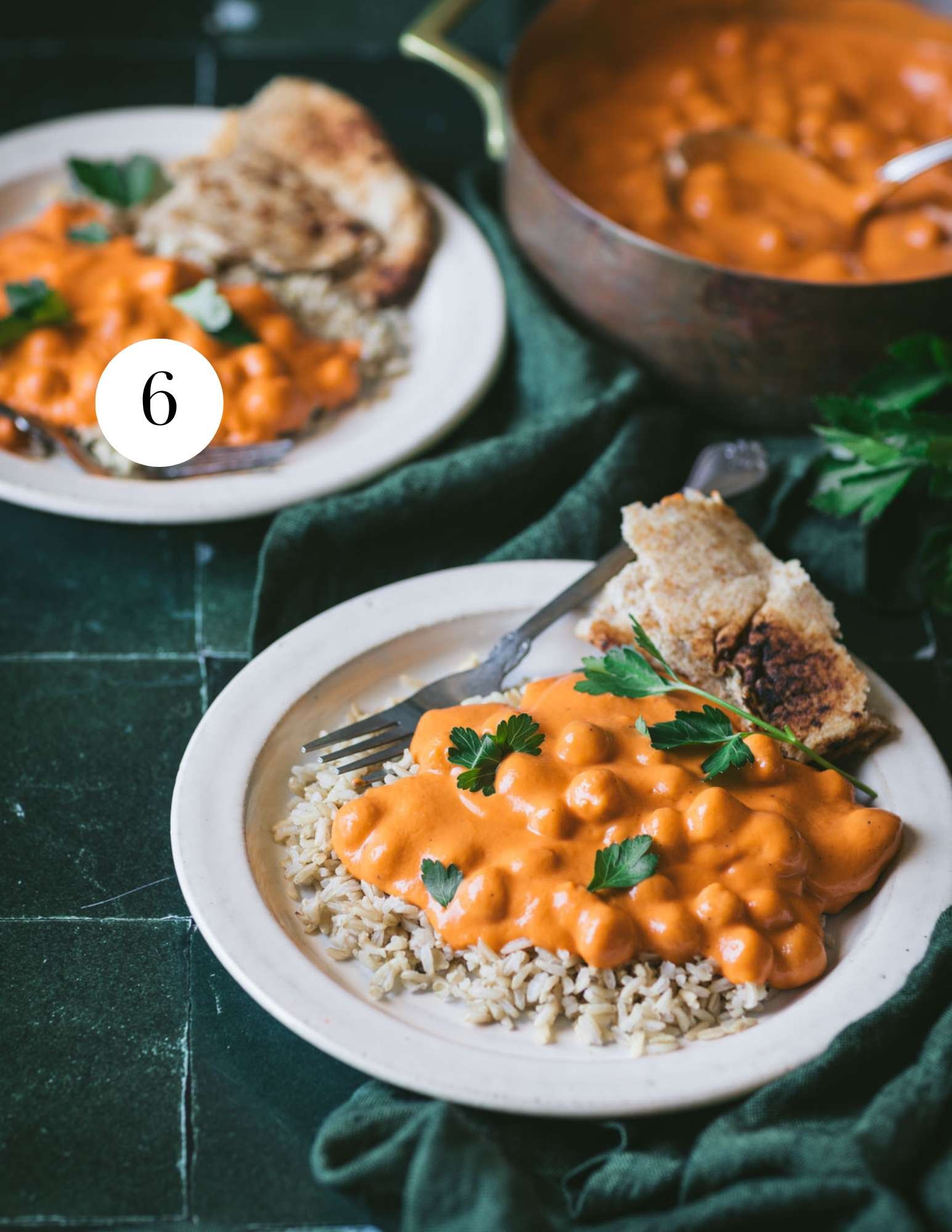 curry served over rice on a plate.