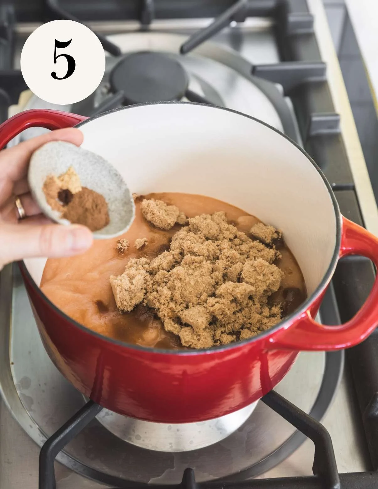Apple butter on the stovetop with sugar and spices.