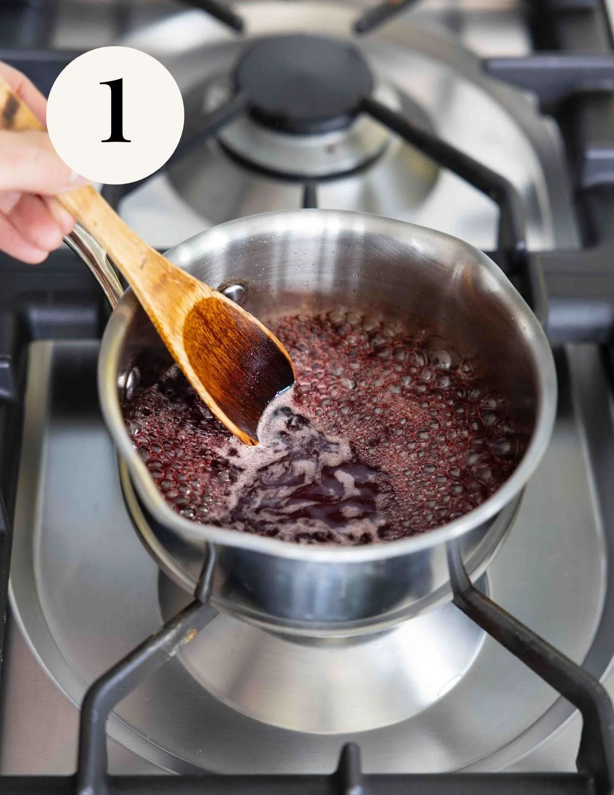 pomegranate simple syrup bubbling on the stovetop