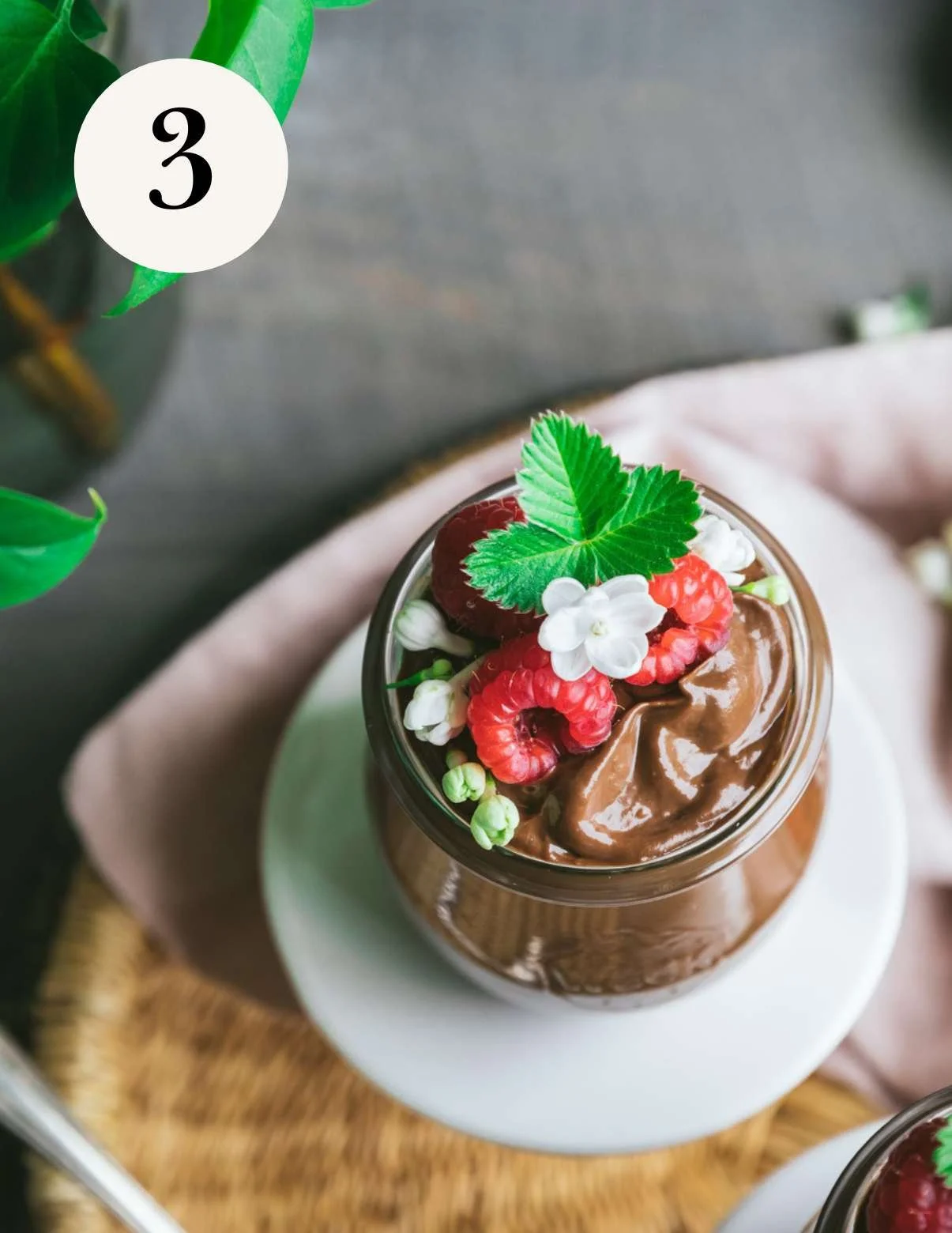 vegan avocado chocolate mousse in a jar with berries on top